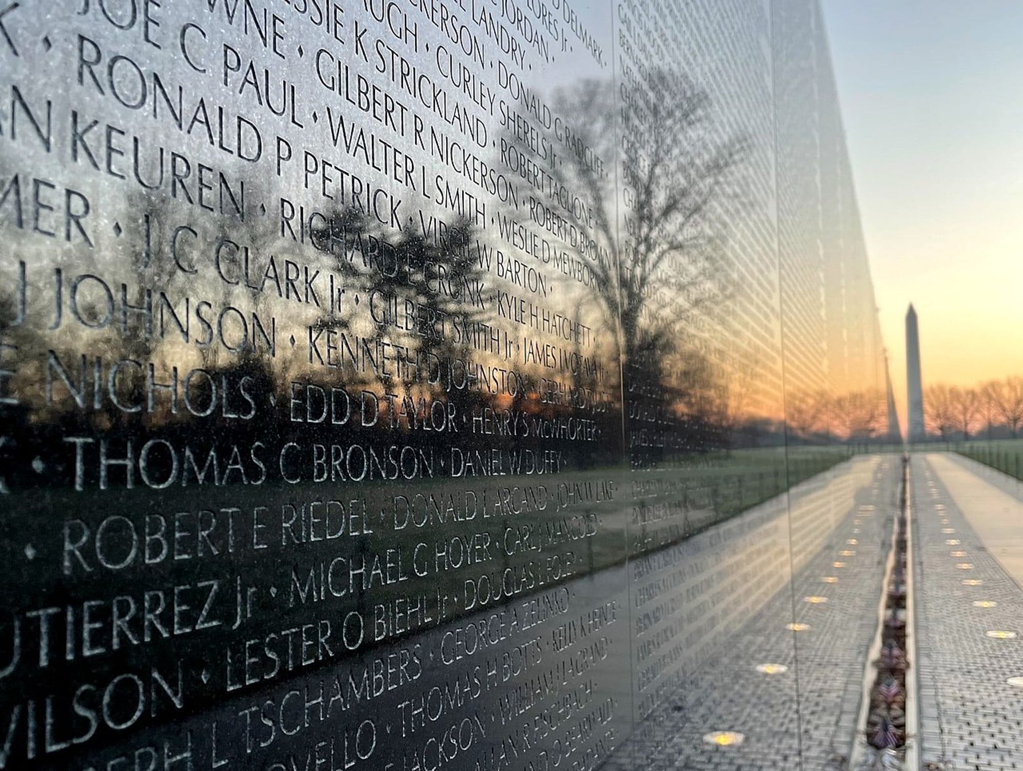 An image of the Vietnam Veterans Memorial in D.C. at sunset