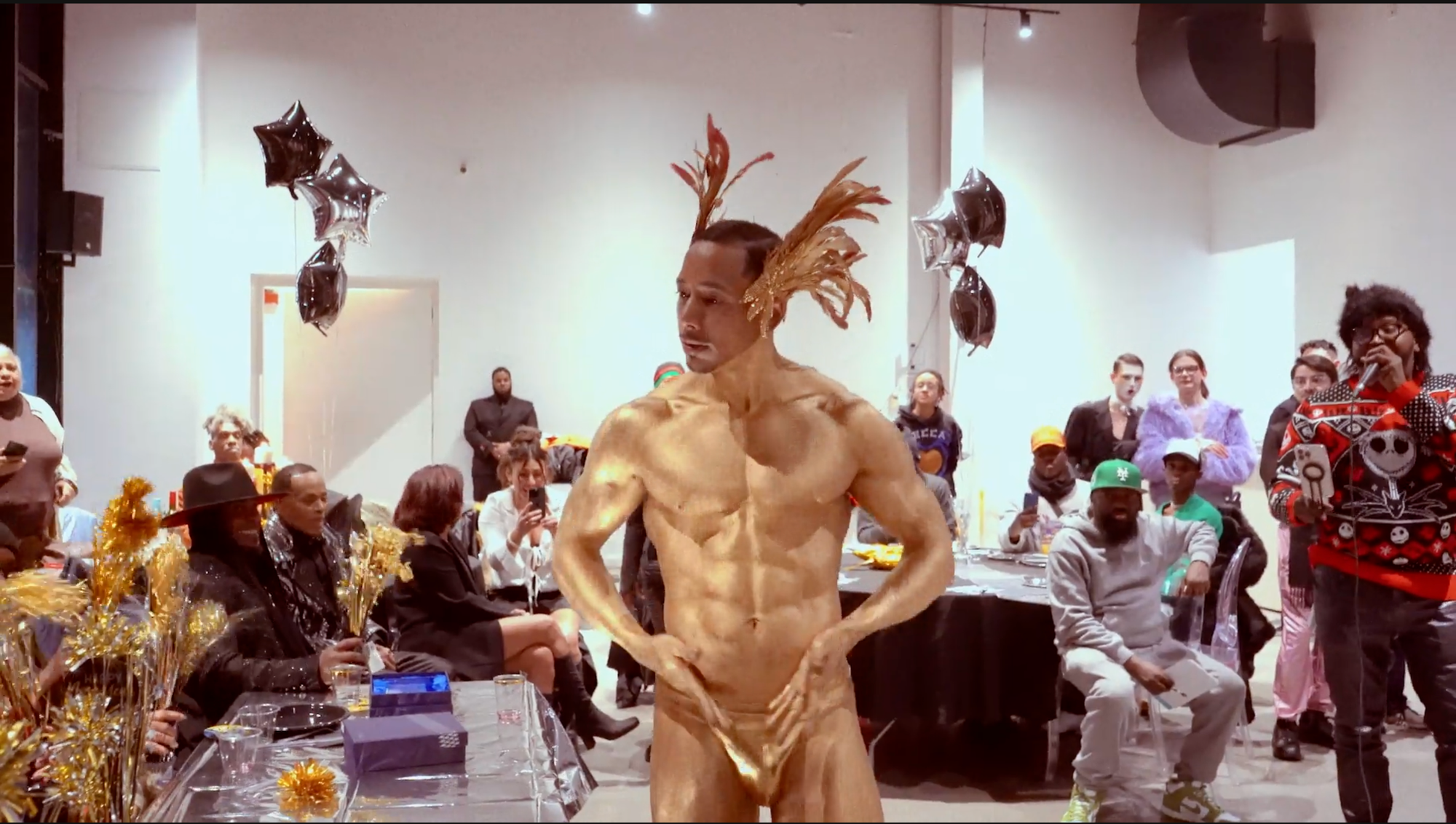 Man in gold body paint and gold underwear at ballroom show