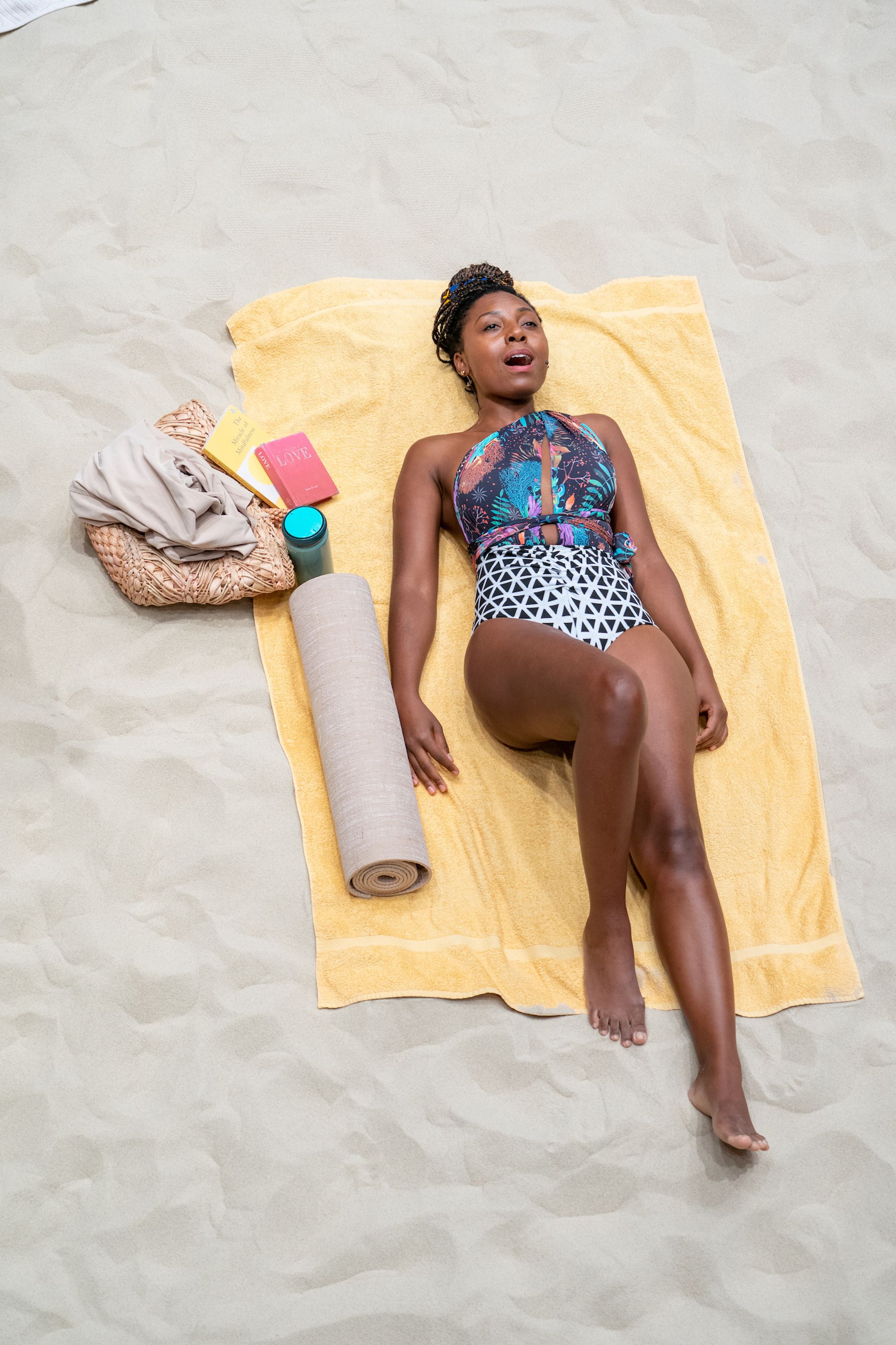 A woman reclining on a beach towel