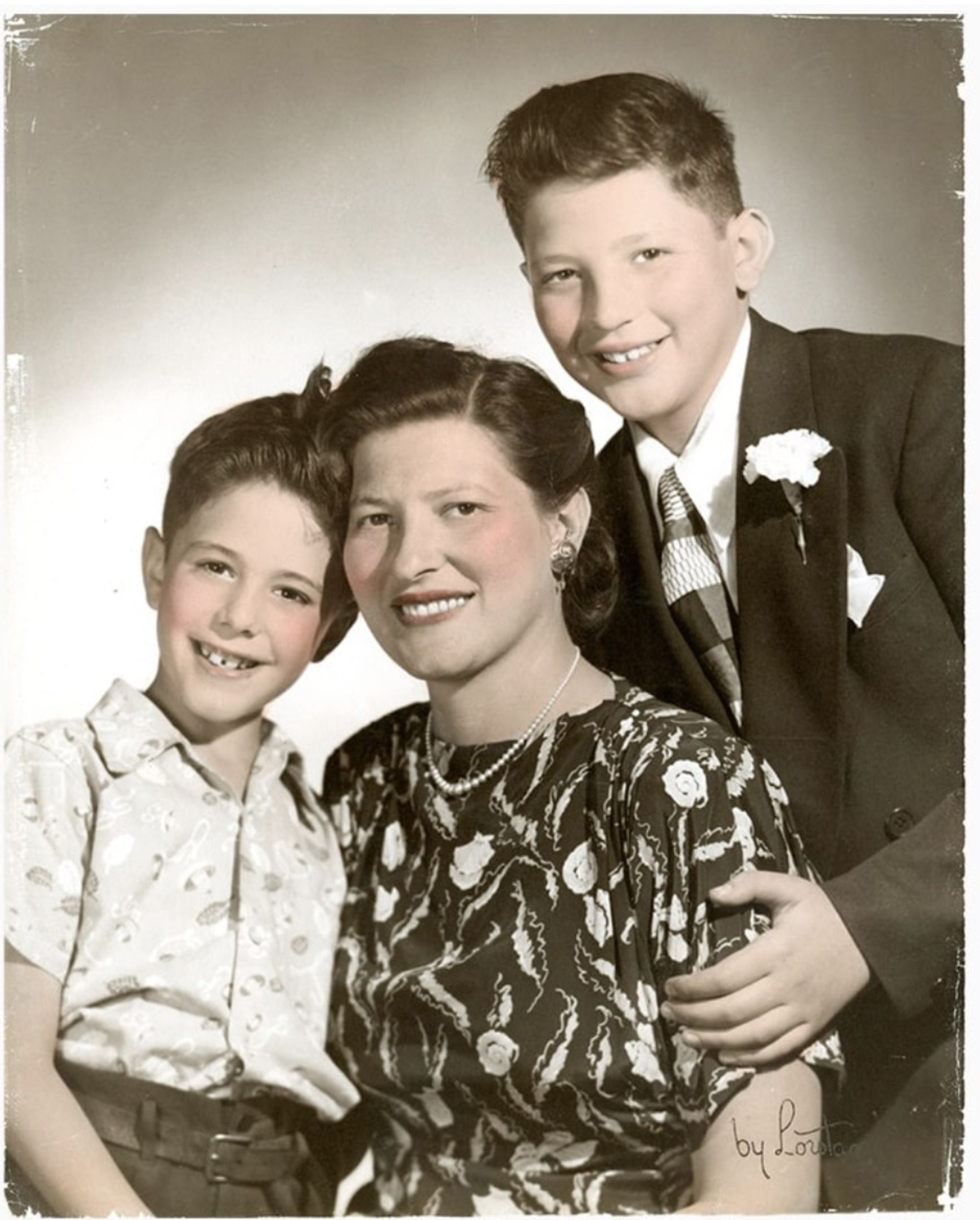 A sepia-toned, artificially colored photograph of Bernie Sanders as a young boy with his mother and brother.