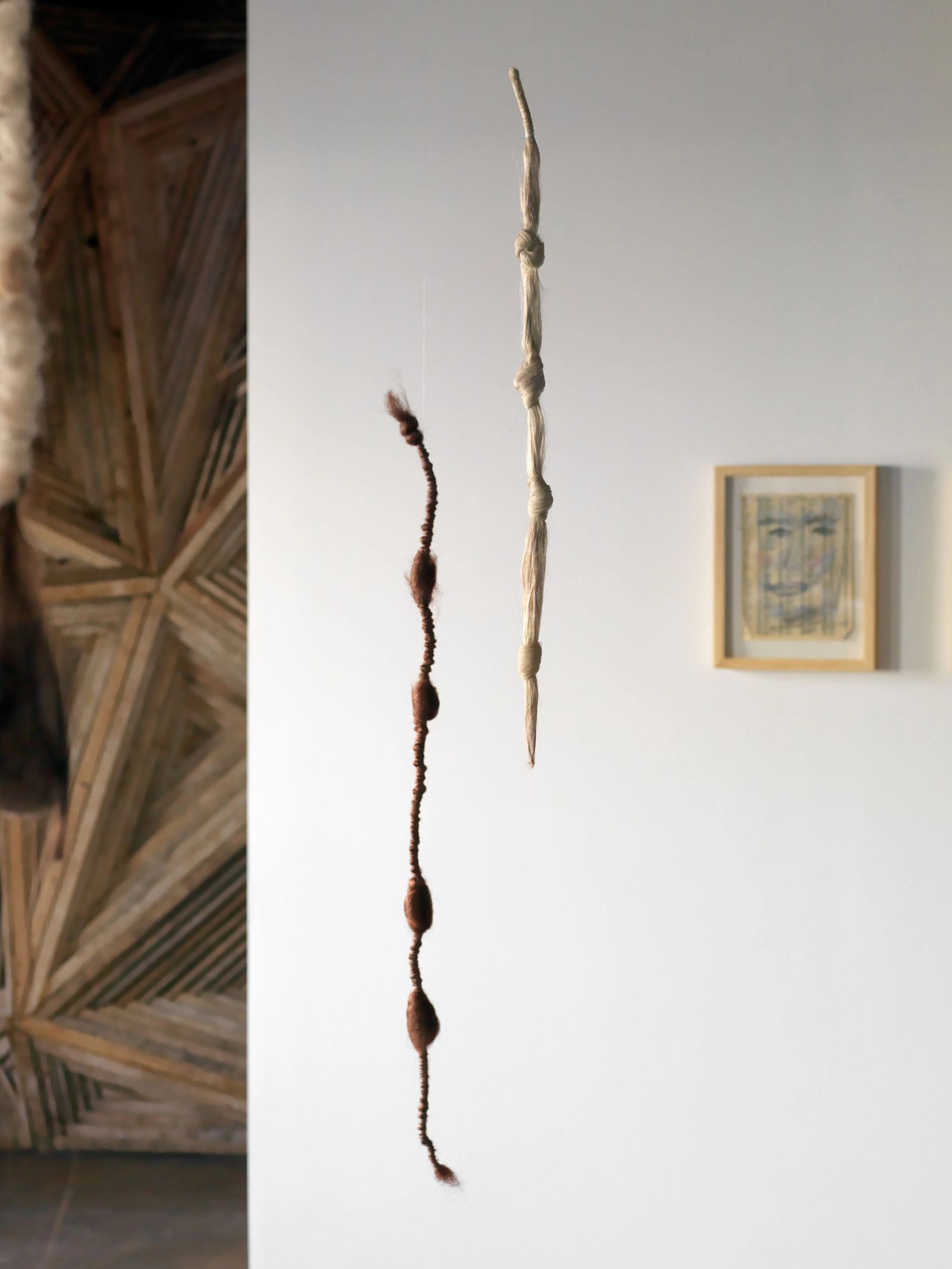 A long, tendril-like hair work