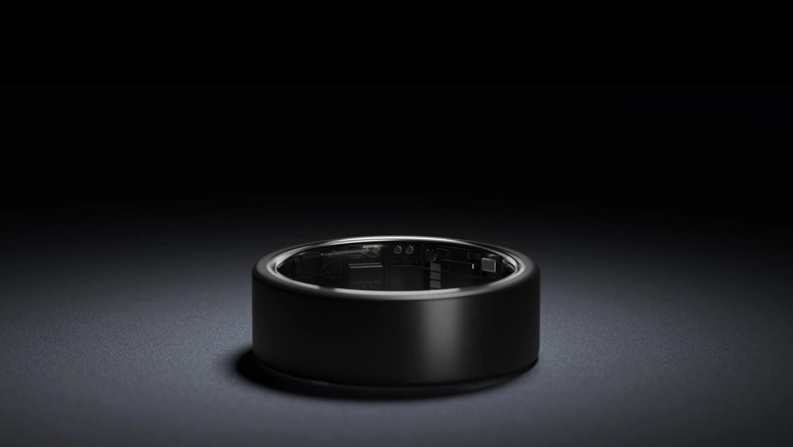 Dark smart ring in a softly lit studio