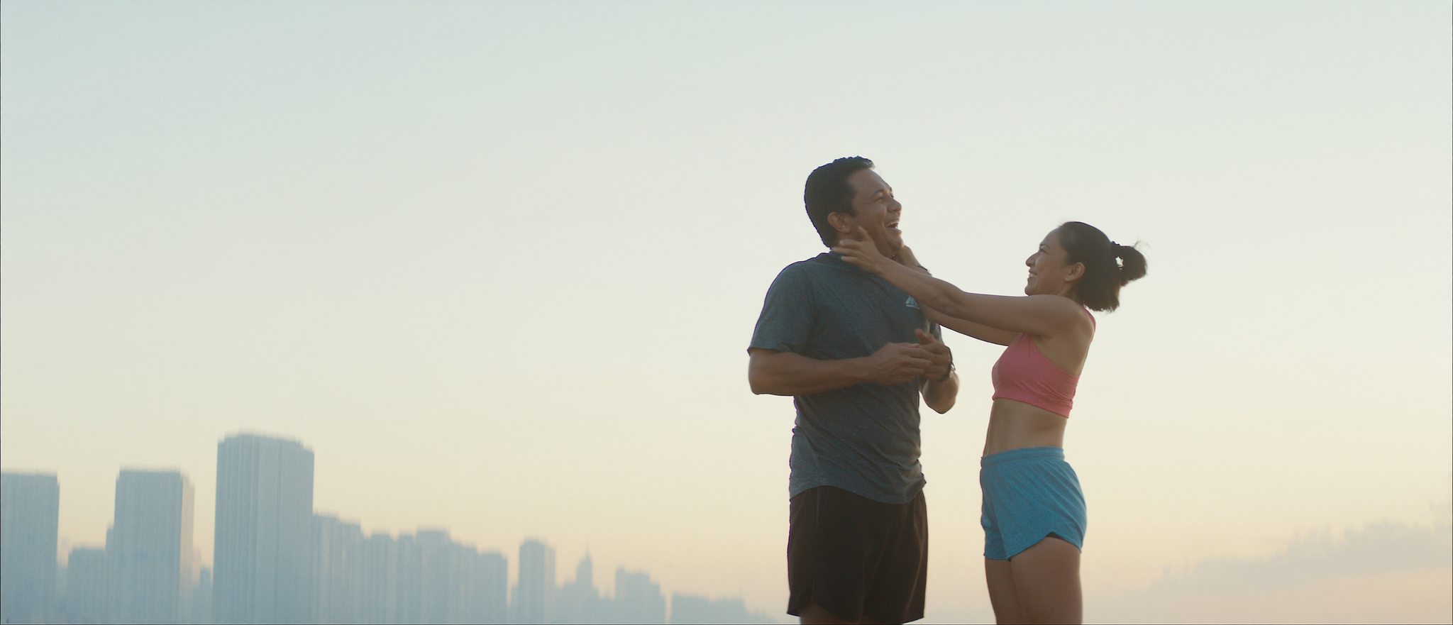 Two friends laughing after an early morning run along Manila Bay
