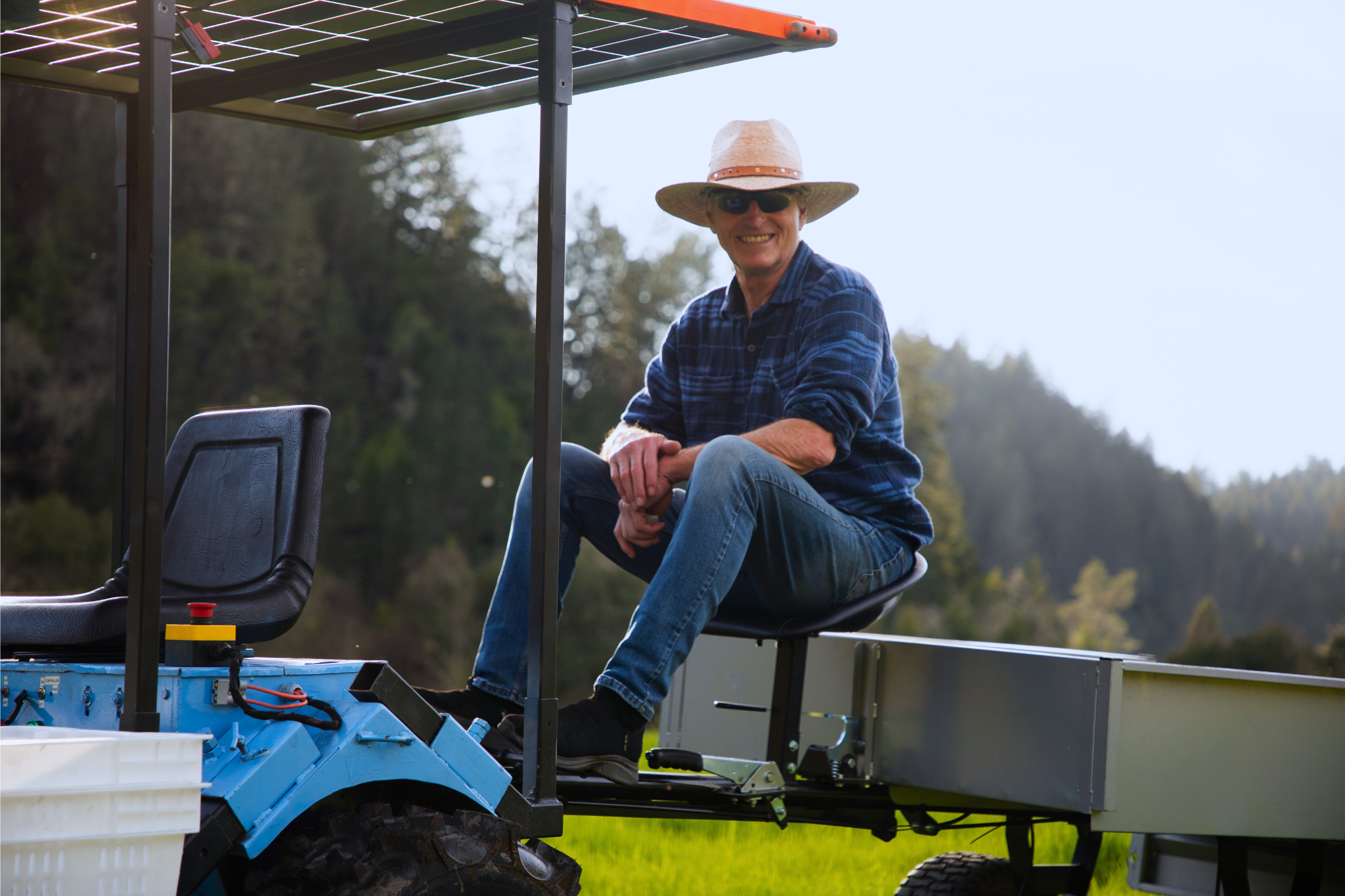 Renewables founder, Steve Heckeroth sits on an e2T under the solar canopy.