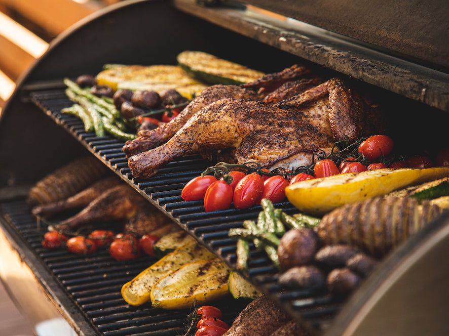 Delicious grilled food cooked on a pellet grill showing perfectly seared meats and vegetables