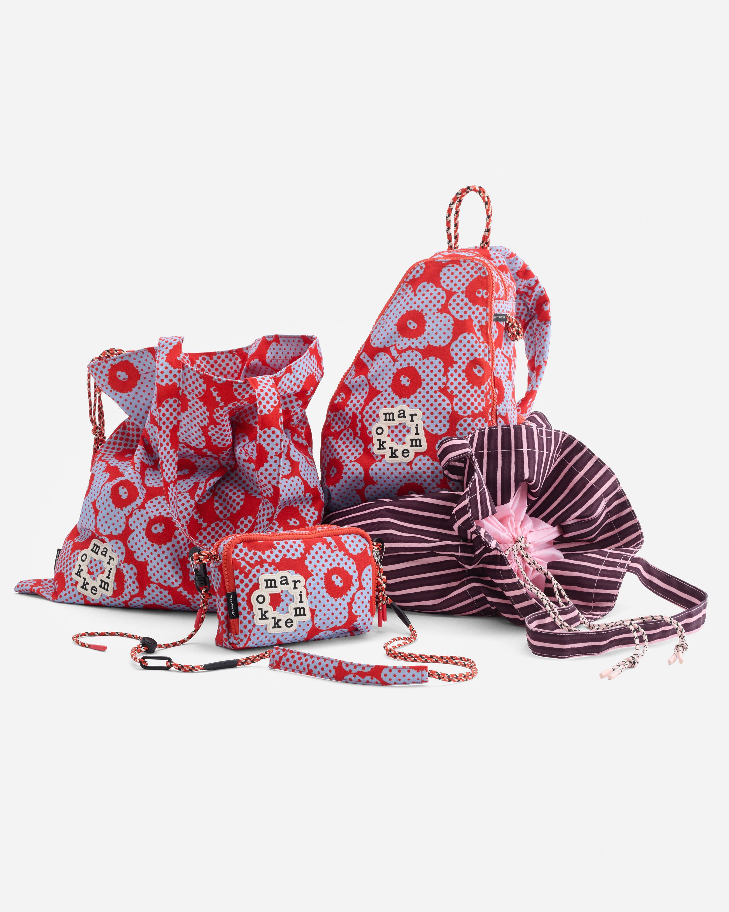A collection of Onni bags in red and light blue Unikko pattern.