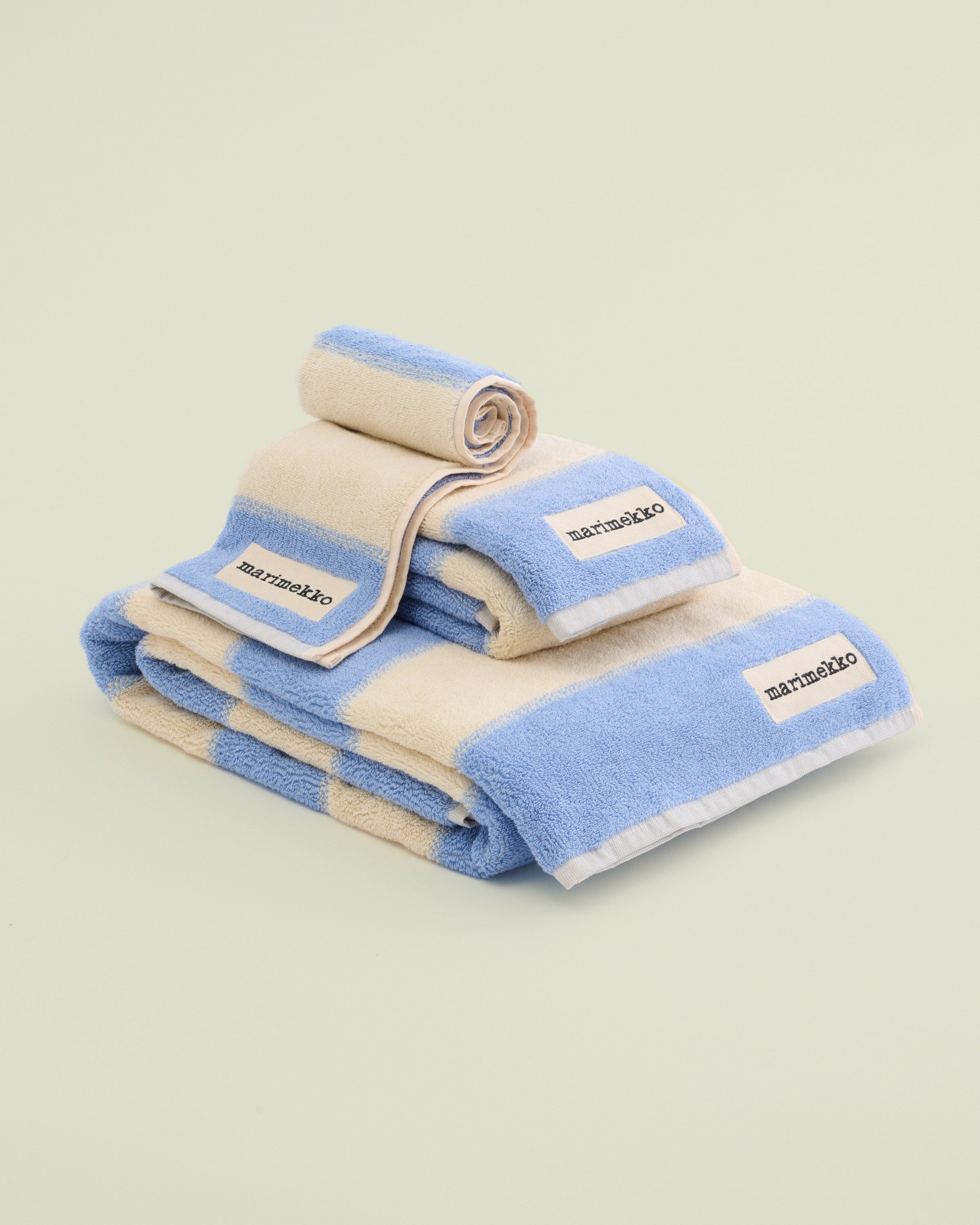 Various size blue and white towels folded on top of each other.