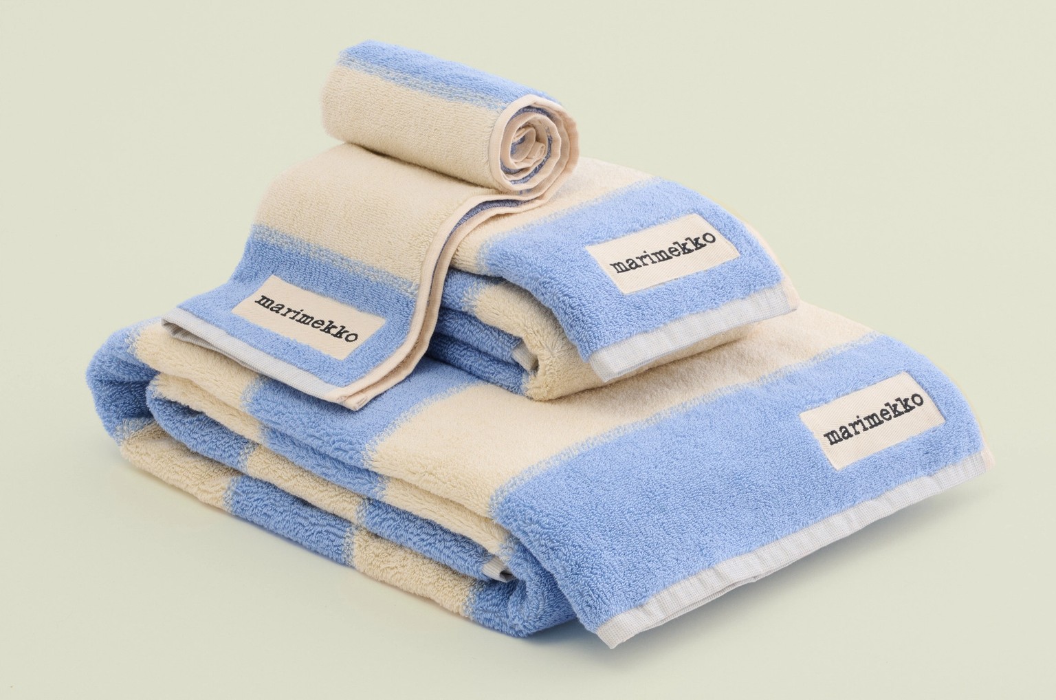 Various size blue and white towels folded on top of each other.