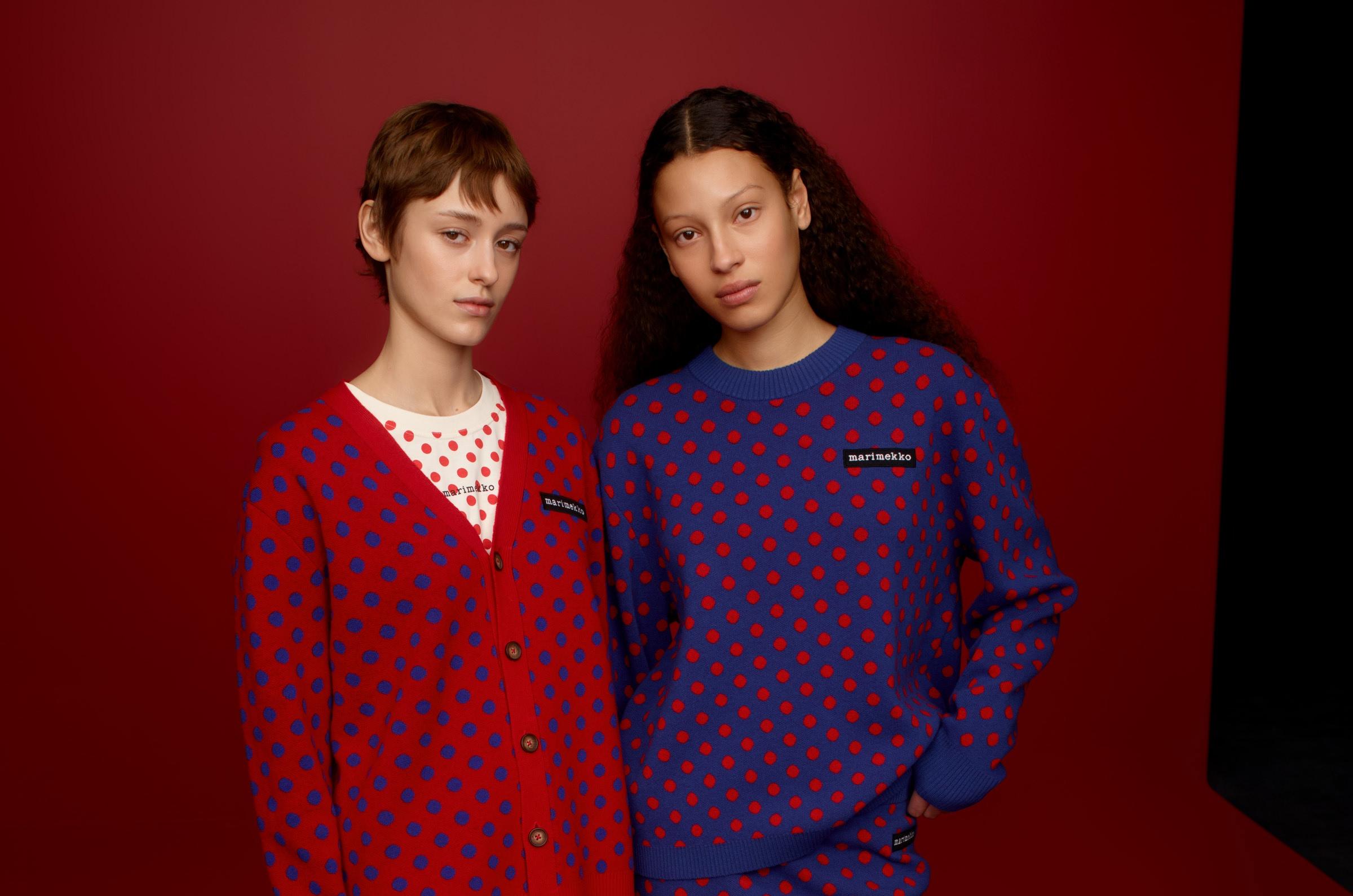 Two models wearing Marimekko Kioski knits and knitted skirts in red and purple Pallo print.