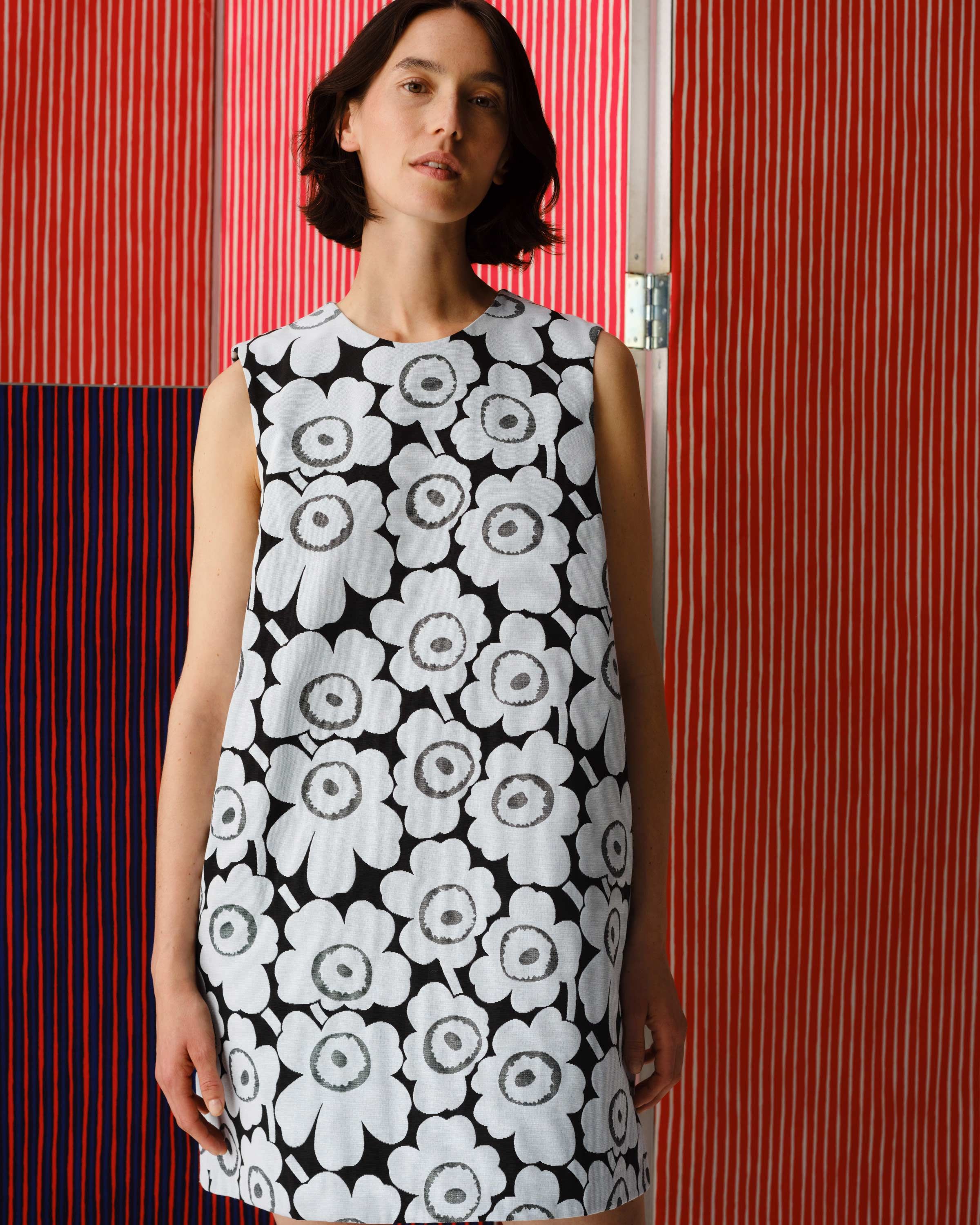 Model wearing dress in Unikko print.