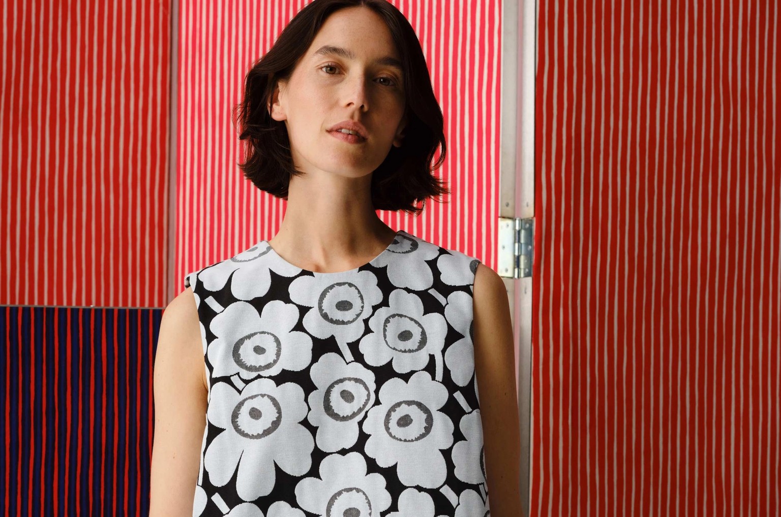 Model wearing dress in Unikko print.
