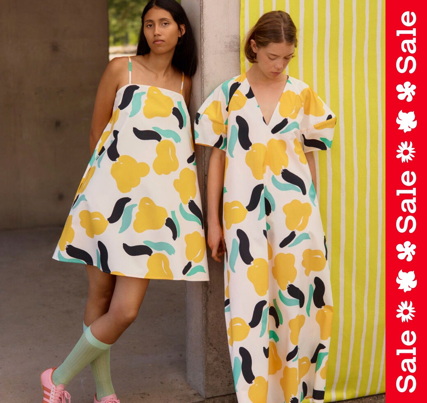 Models wearing Pelit dress and Taivut dress in Lemmitty print. On the side a vertical textline ''Sale''.
