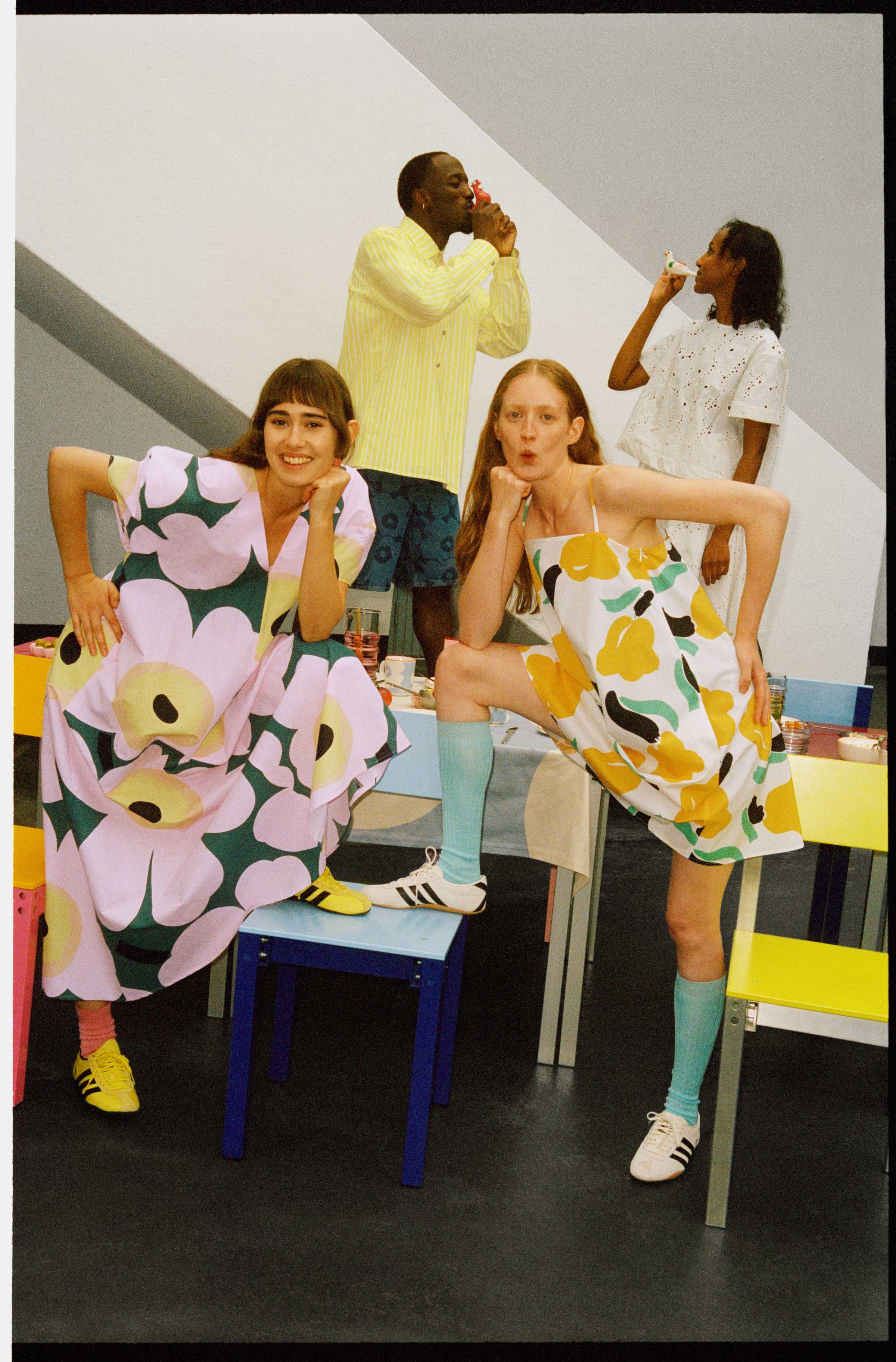 Four models wearing dresses in Unikko and Lemmitty prints and shirts and shorts in Unikko and Piccolo print.