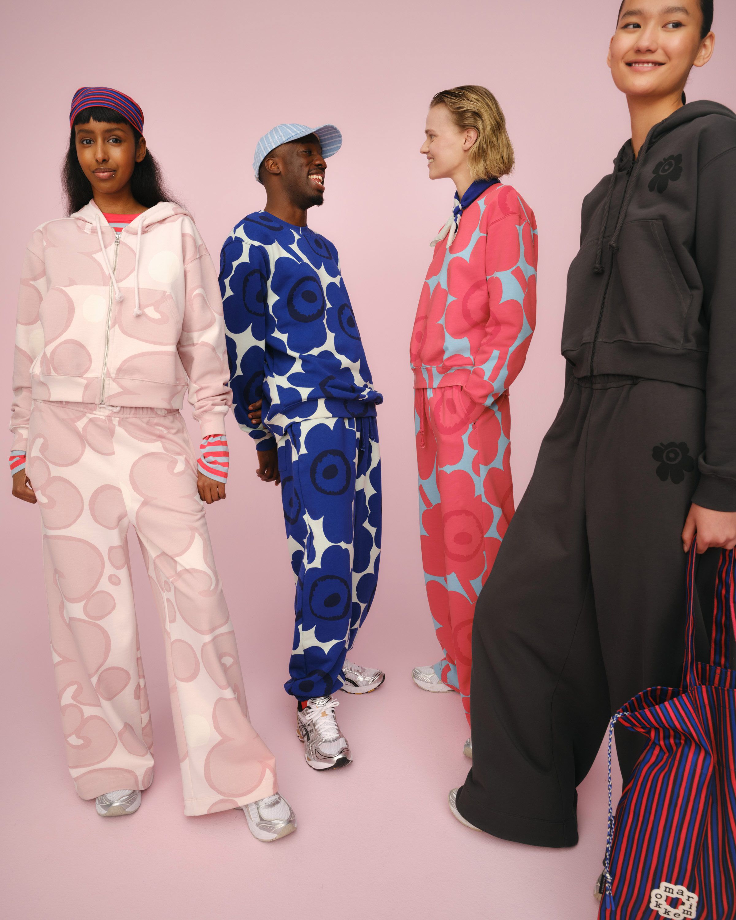 Four models wearing Marimekko sweatshirts, hoodies and sweatpants in joyful colors and prints.