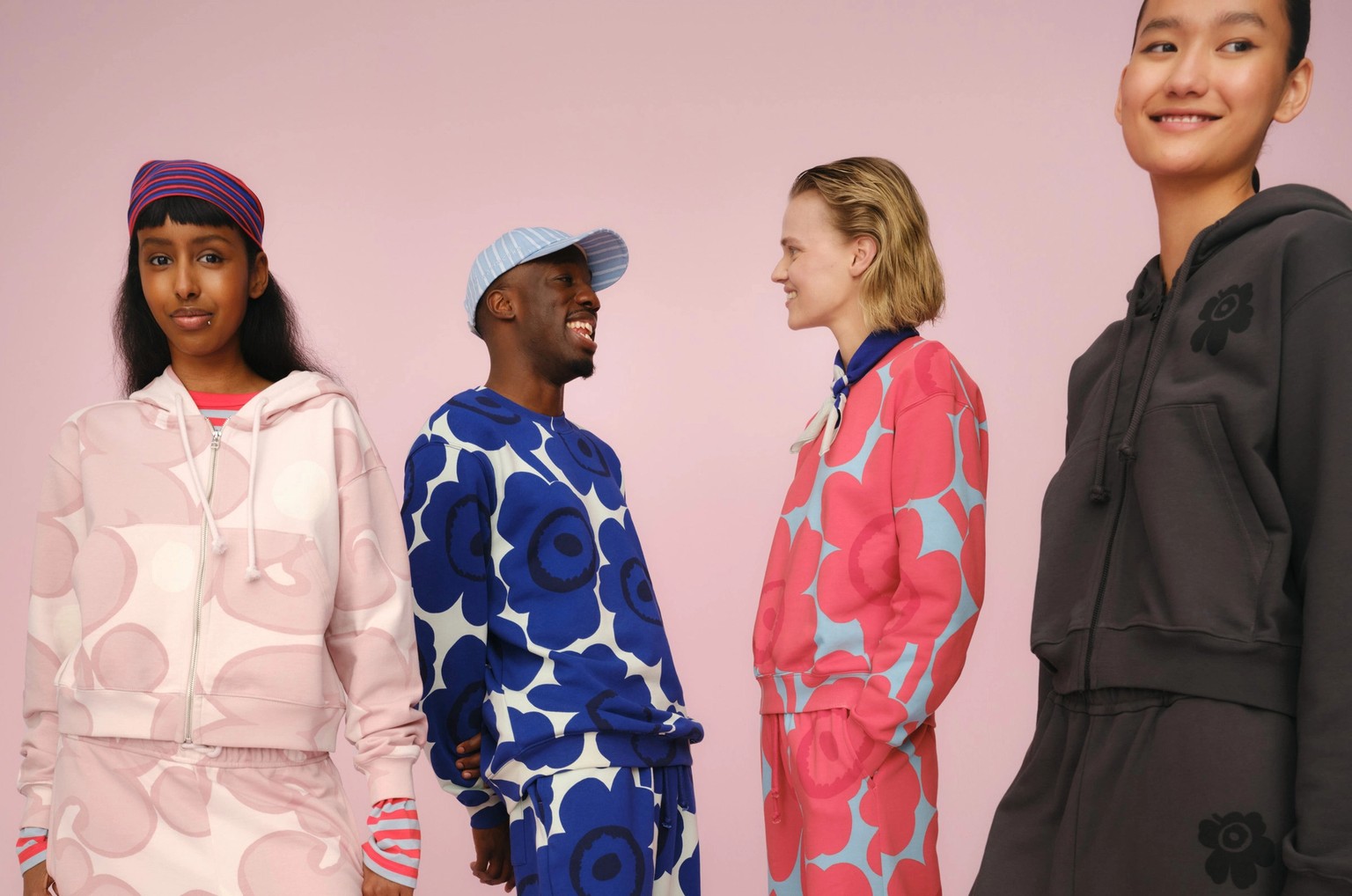 Four models wearing Marimekko sweatshirts, hoodies and sweatpants in joyful colors and prints.
