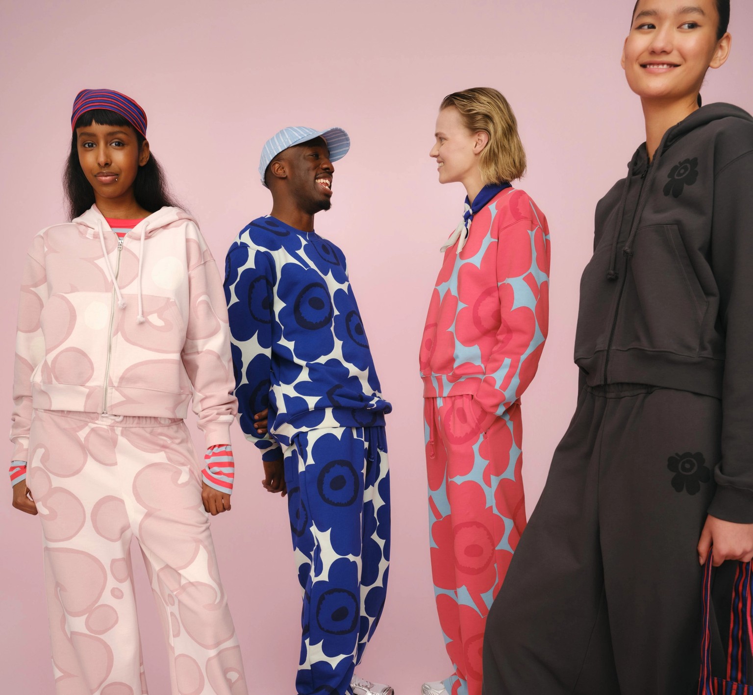 Four models wearing Marimekko sweatshirts, hoodies and sweatpants in joyful colors and prints.
