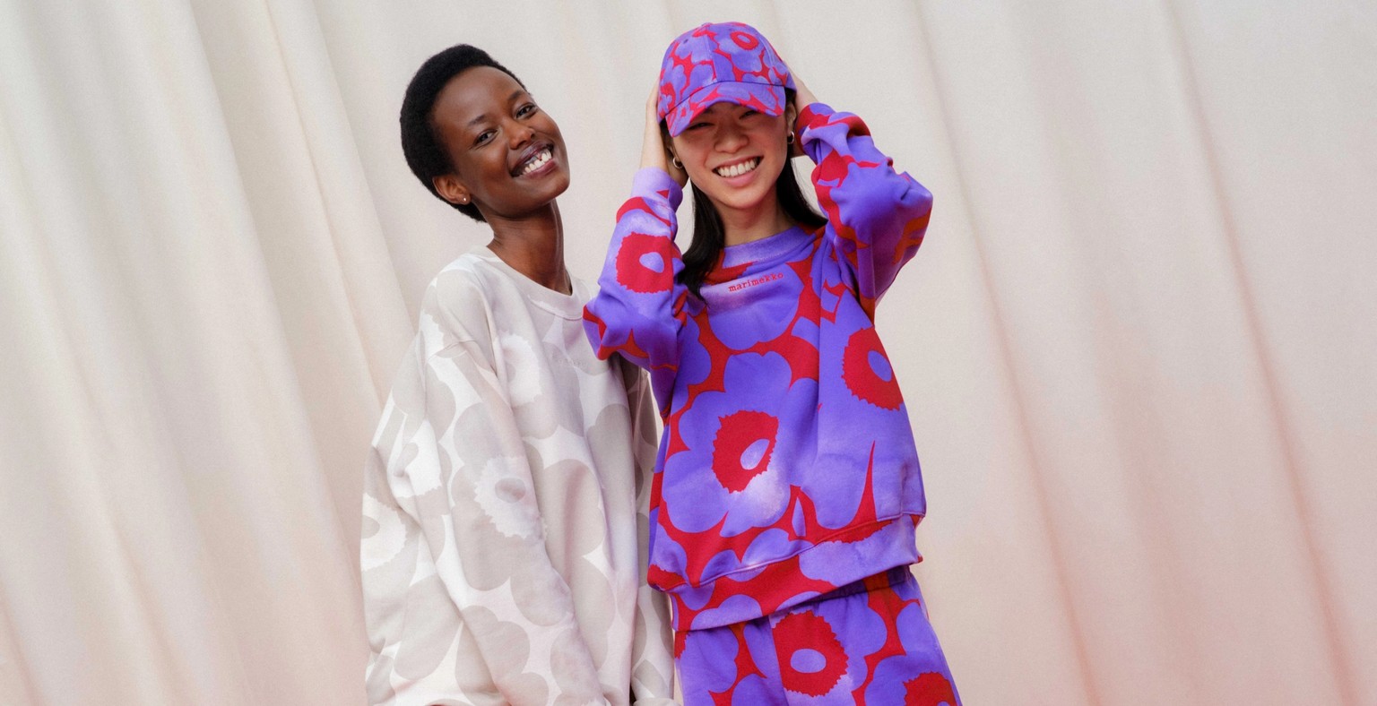 Two models wearing colorful sweatshirts with Unikko print.