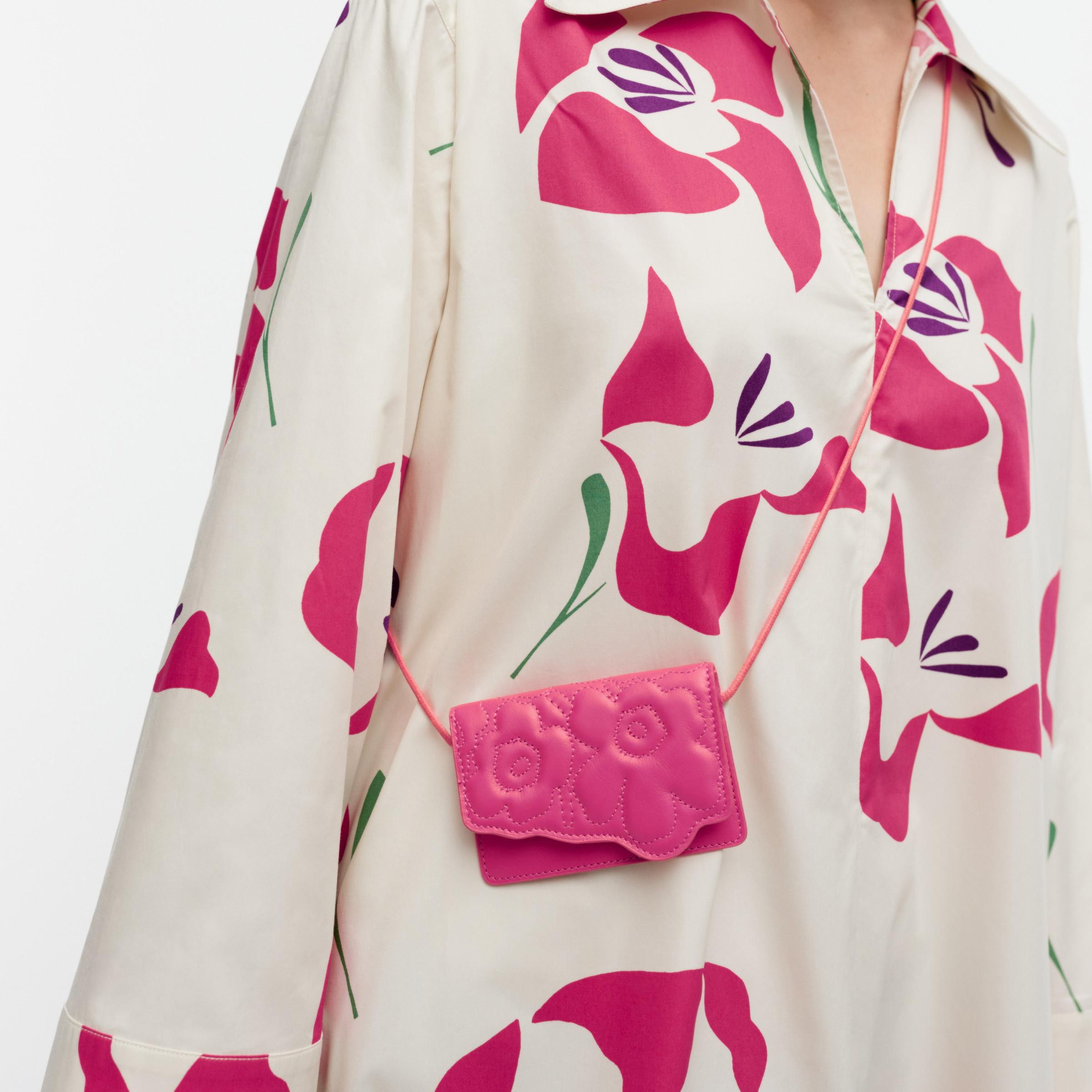 Model wearing belt bag in embedded Unikko pattern.