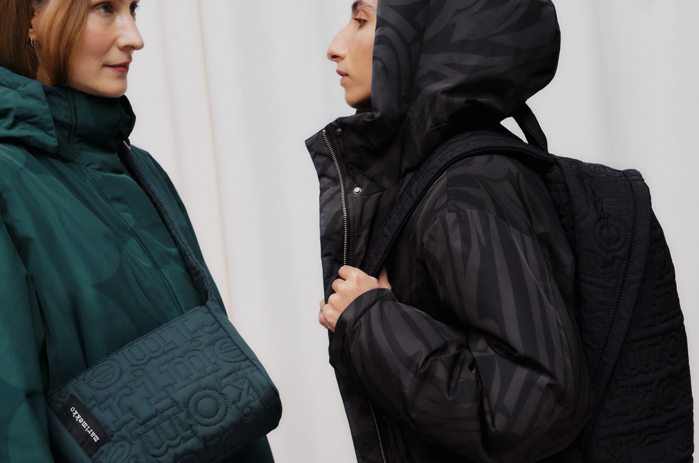 Models wearing coats and carrying bags from the Joy bag series.