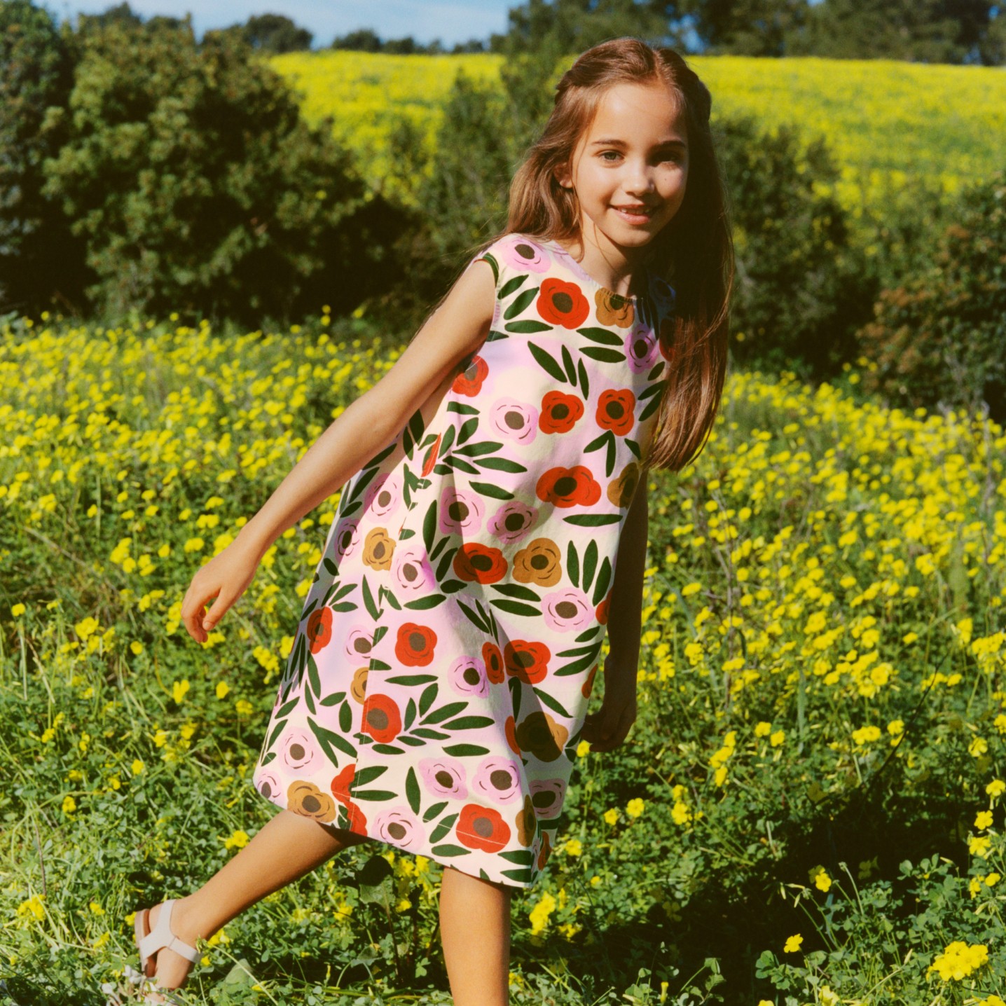 Girl wearing Uniqlo and Marimekko Ruukku pattern dress in flower field