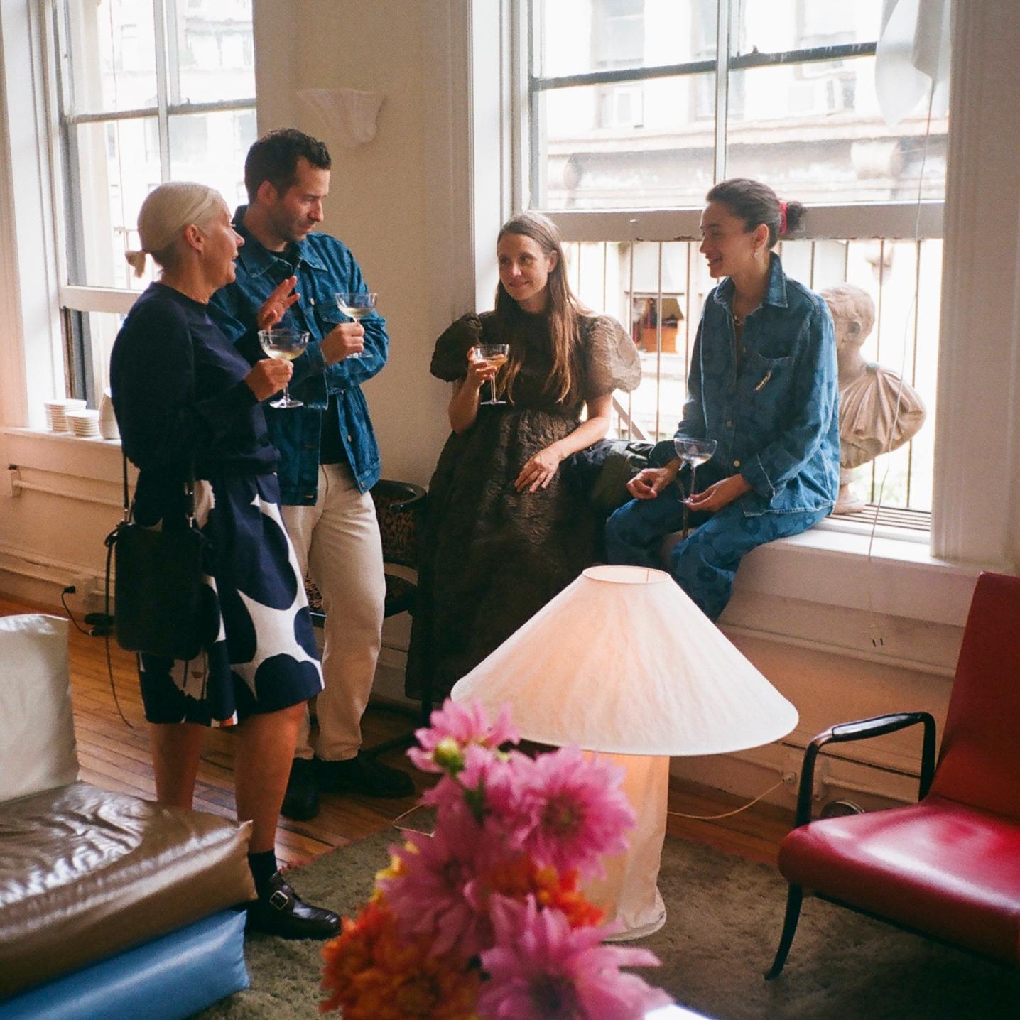 Lunch guests enjoying a drink at Laila Gohar's apartment