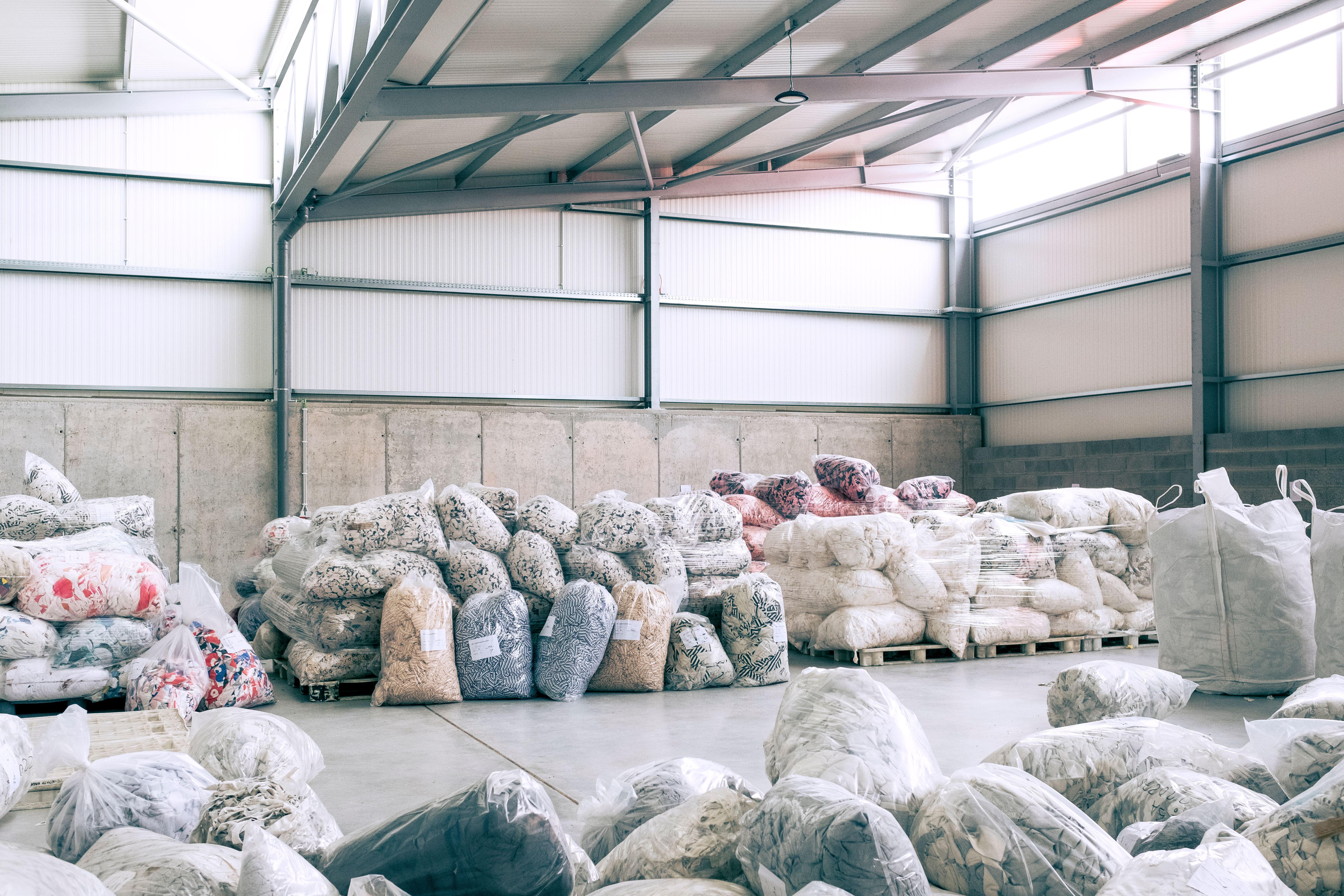 Textile waste material collected into plastic bags.