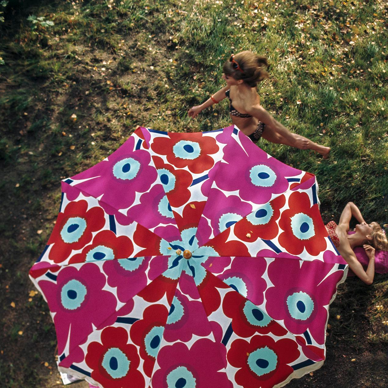 Achive picture where women are enjoying summer under Marimekko parasol
