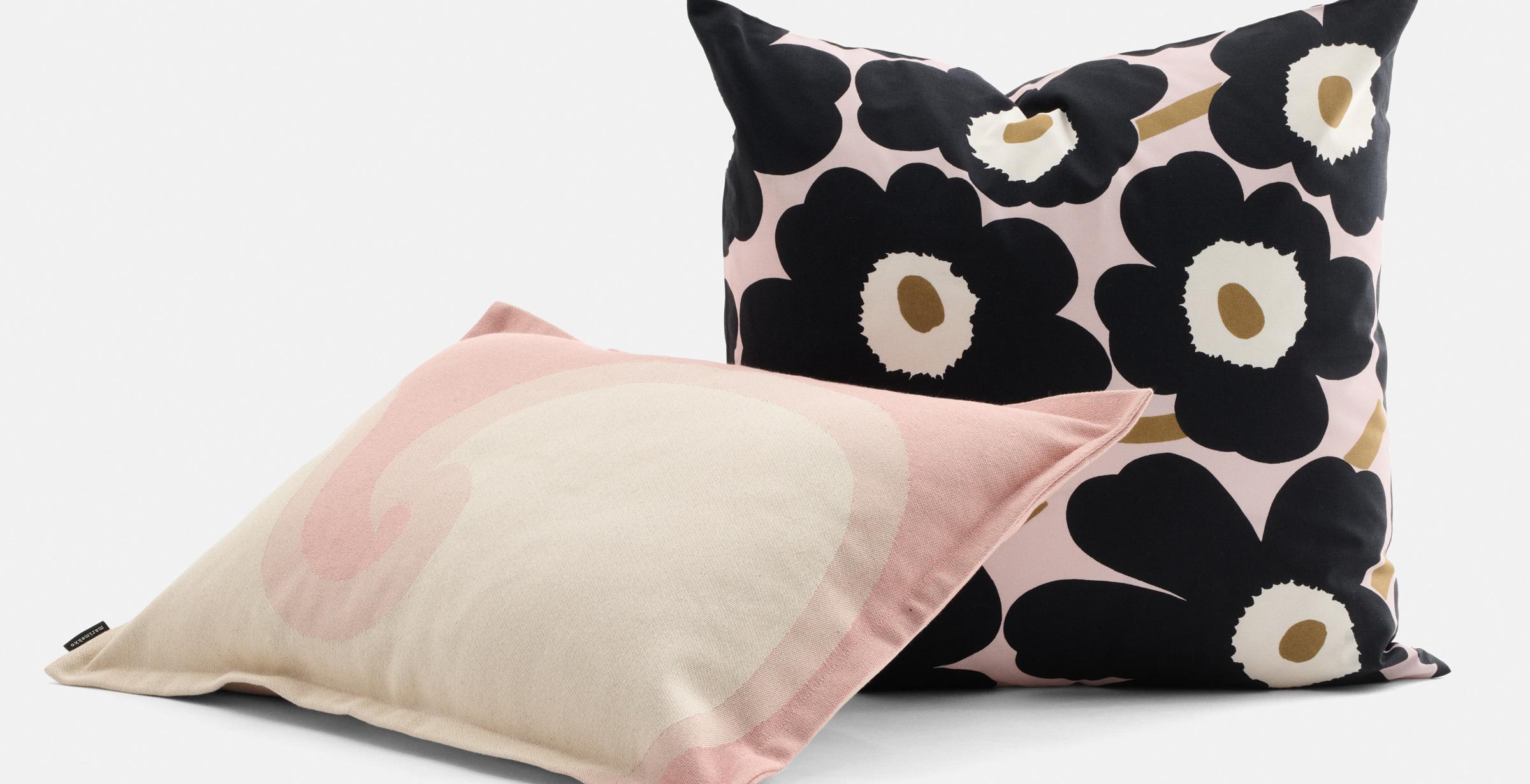 Black Unikko print pillow and pink and white Keidas print pillow.