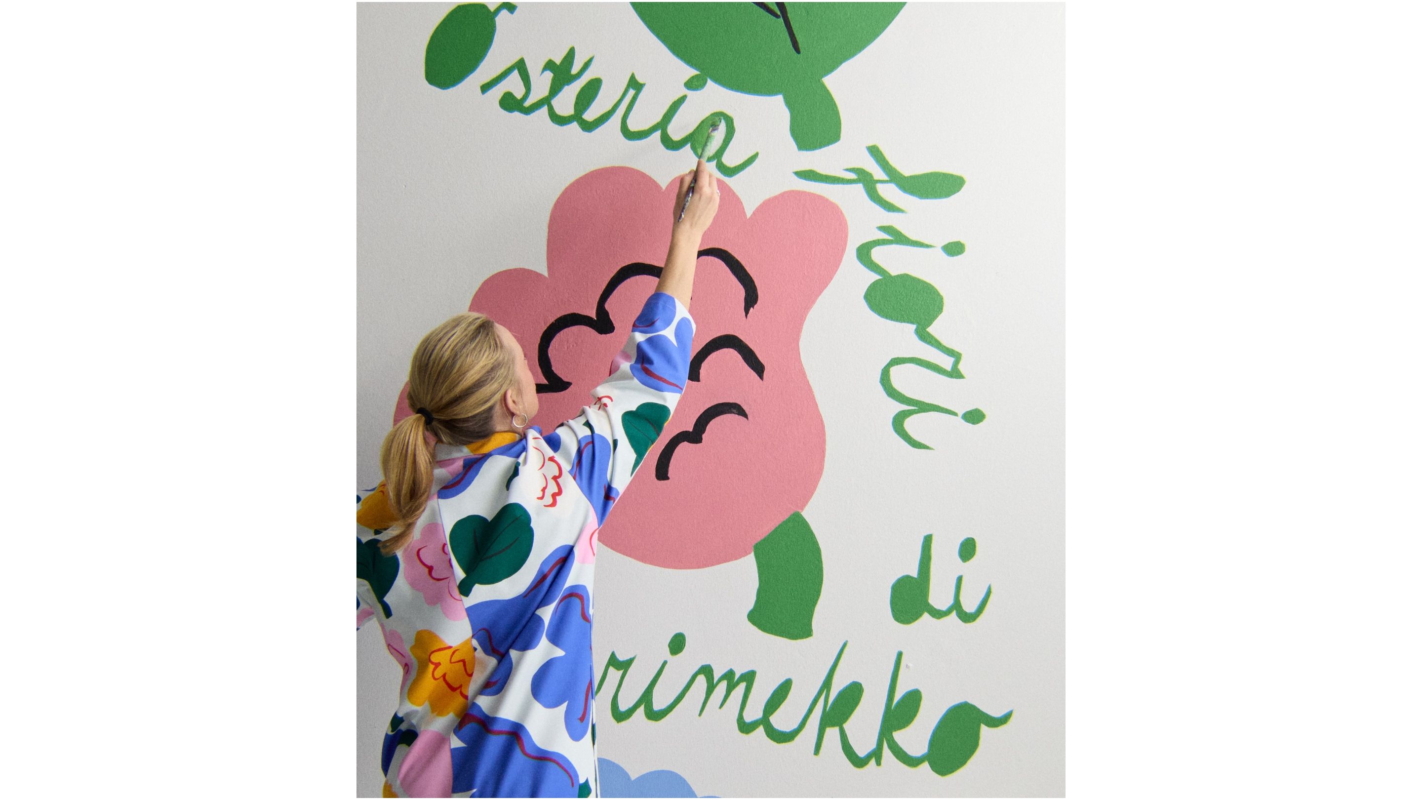 A woman painting a pink flower.
