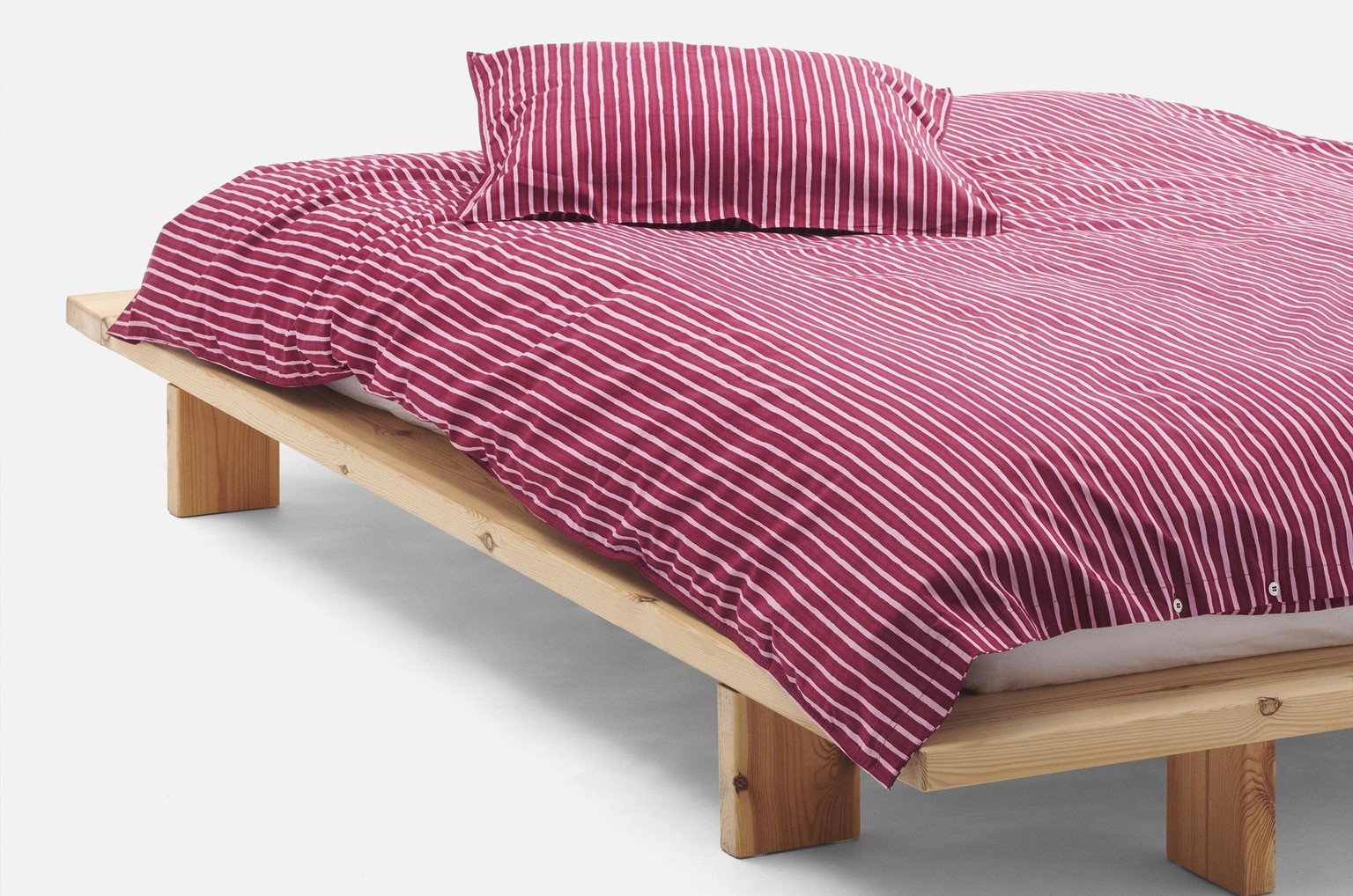 Bedding with Piccolo print placed on a bed.