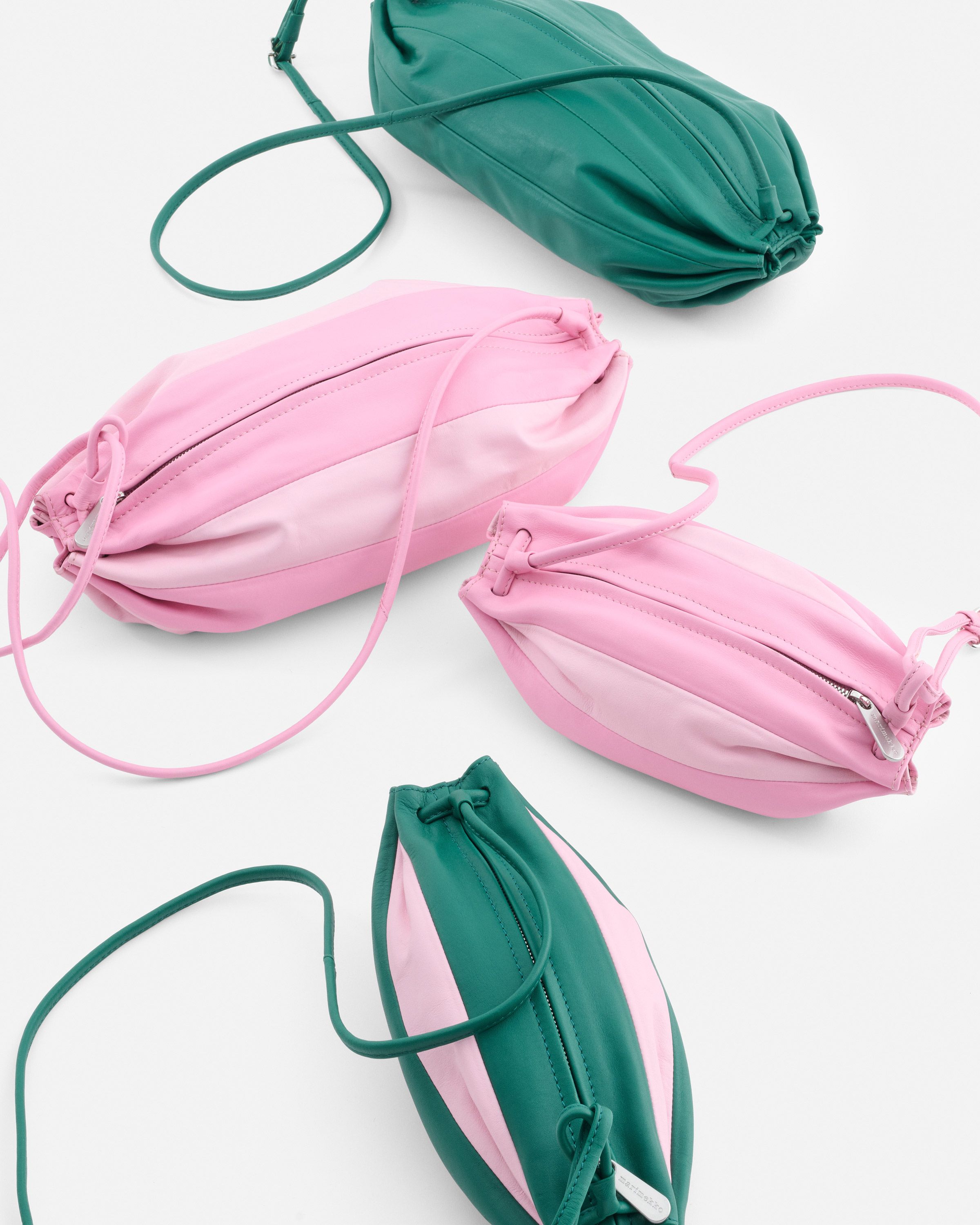 Four different sizes of Karla bags in pink and green tones.
