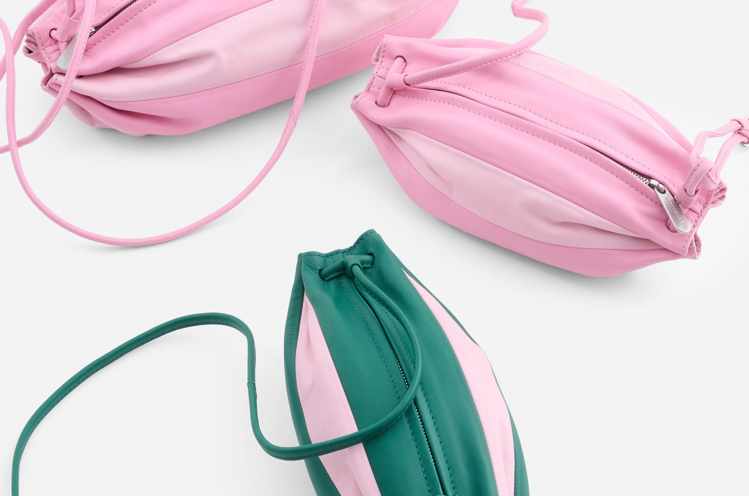 Four different sizes of Karla bags in pink and green tones.