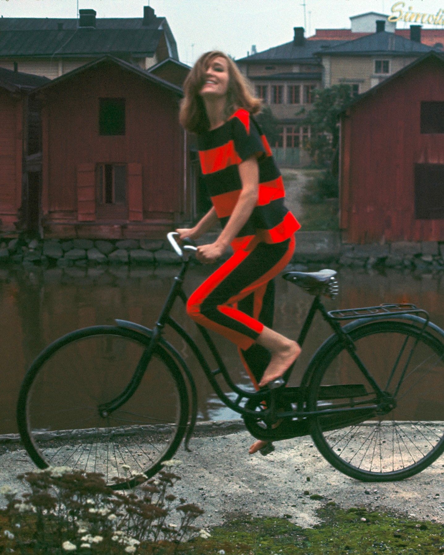 Model on a bicycle wearing Marimekko clothing.