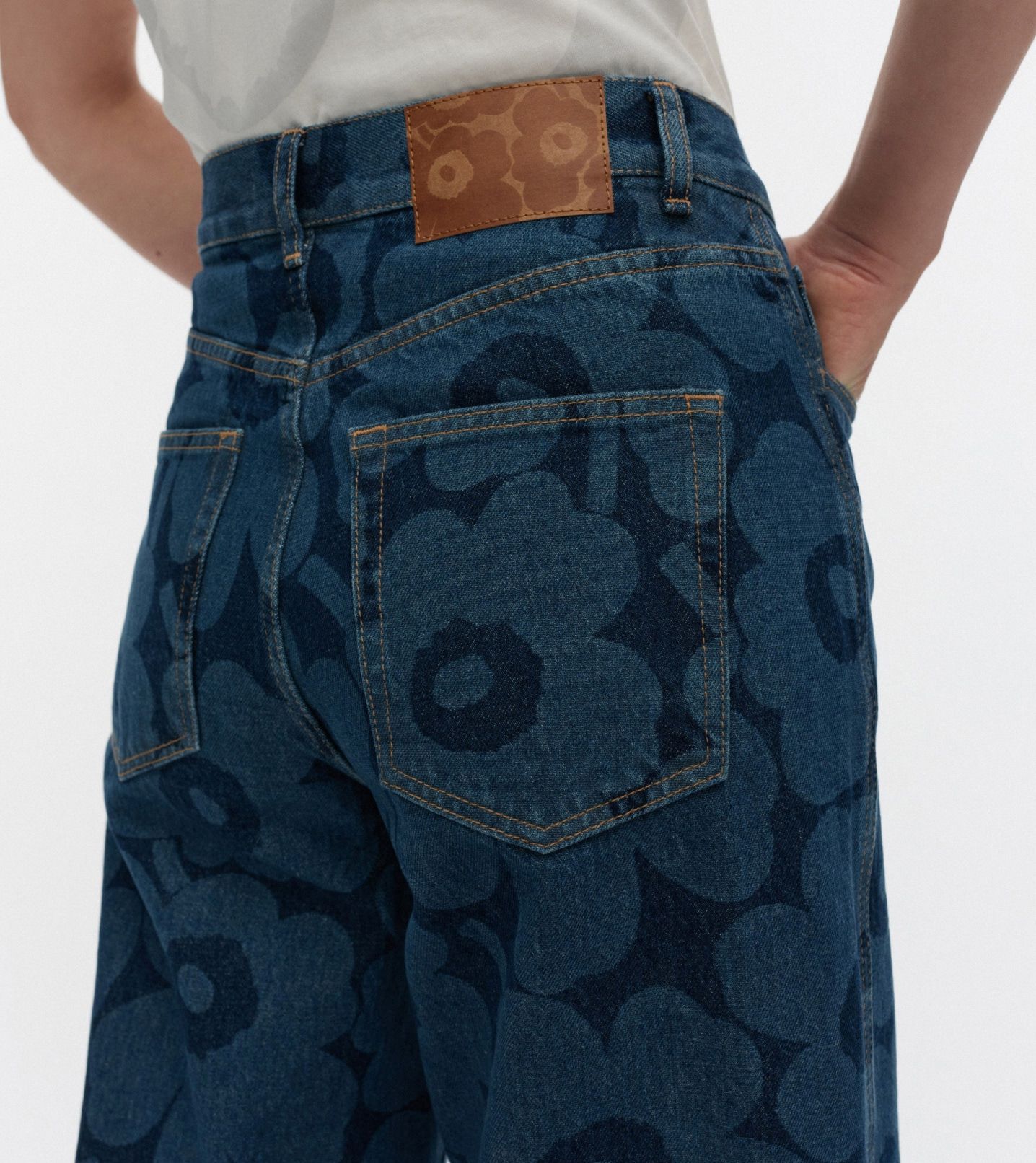 A close up of model wearing Marimekko Maridenim Unikko Wide jeans.