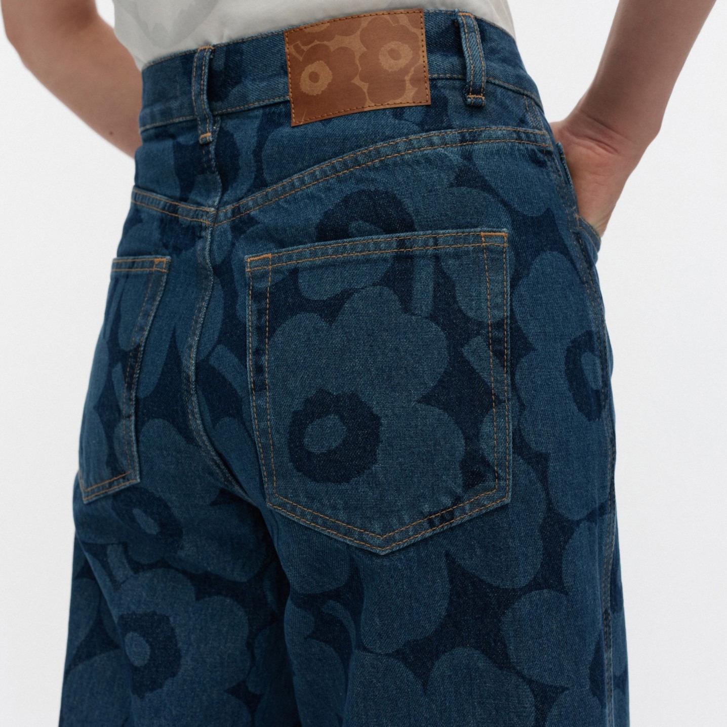 A close up of model wearing Marimekko Maridenim Unikko Wide jeans.