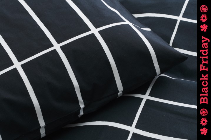 Close up shot of Black bedding with thin white stripes. Image with Black Friday stripe down the right hand side of the frame