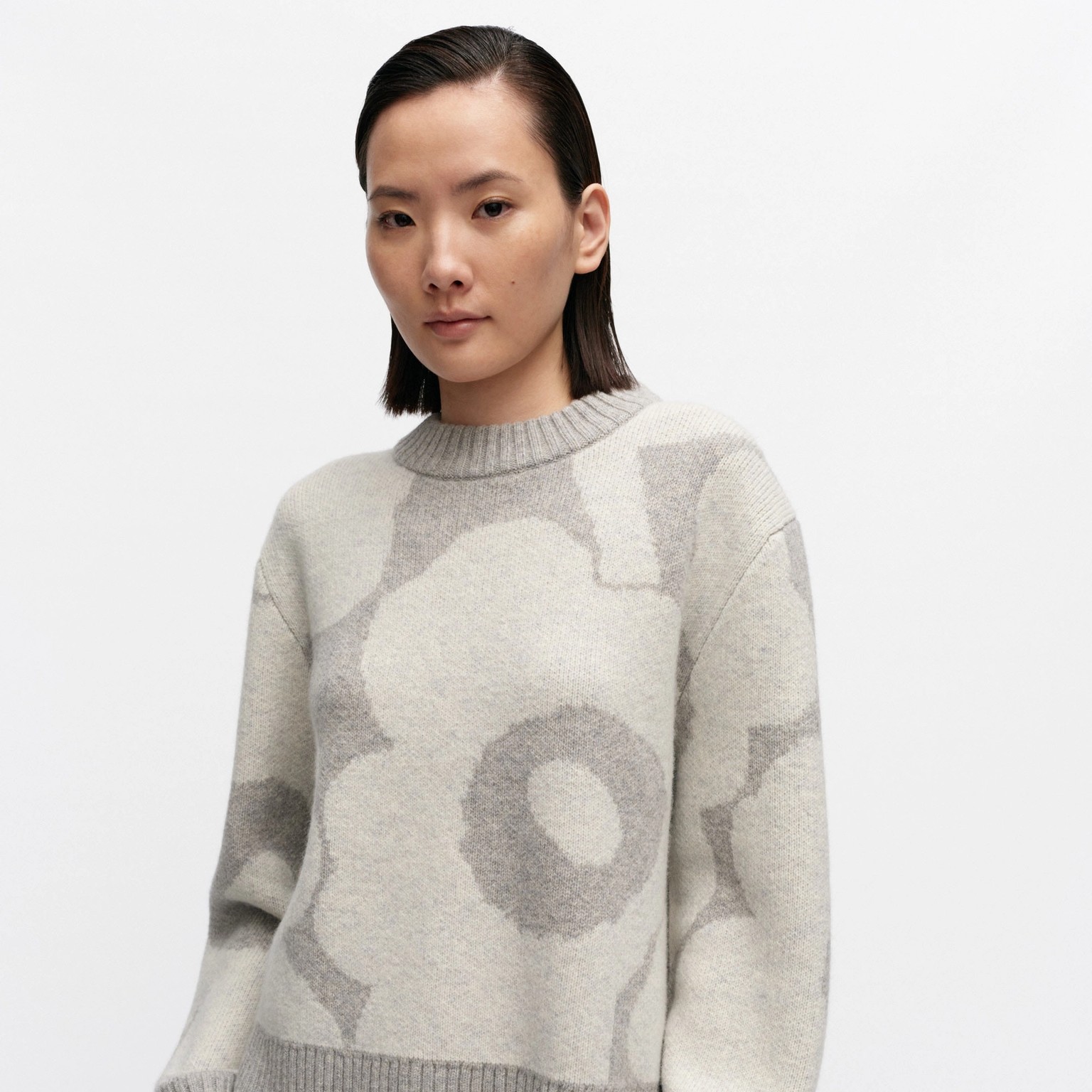 Model wearing wool knit in Unikko pattern.