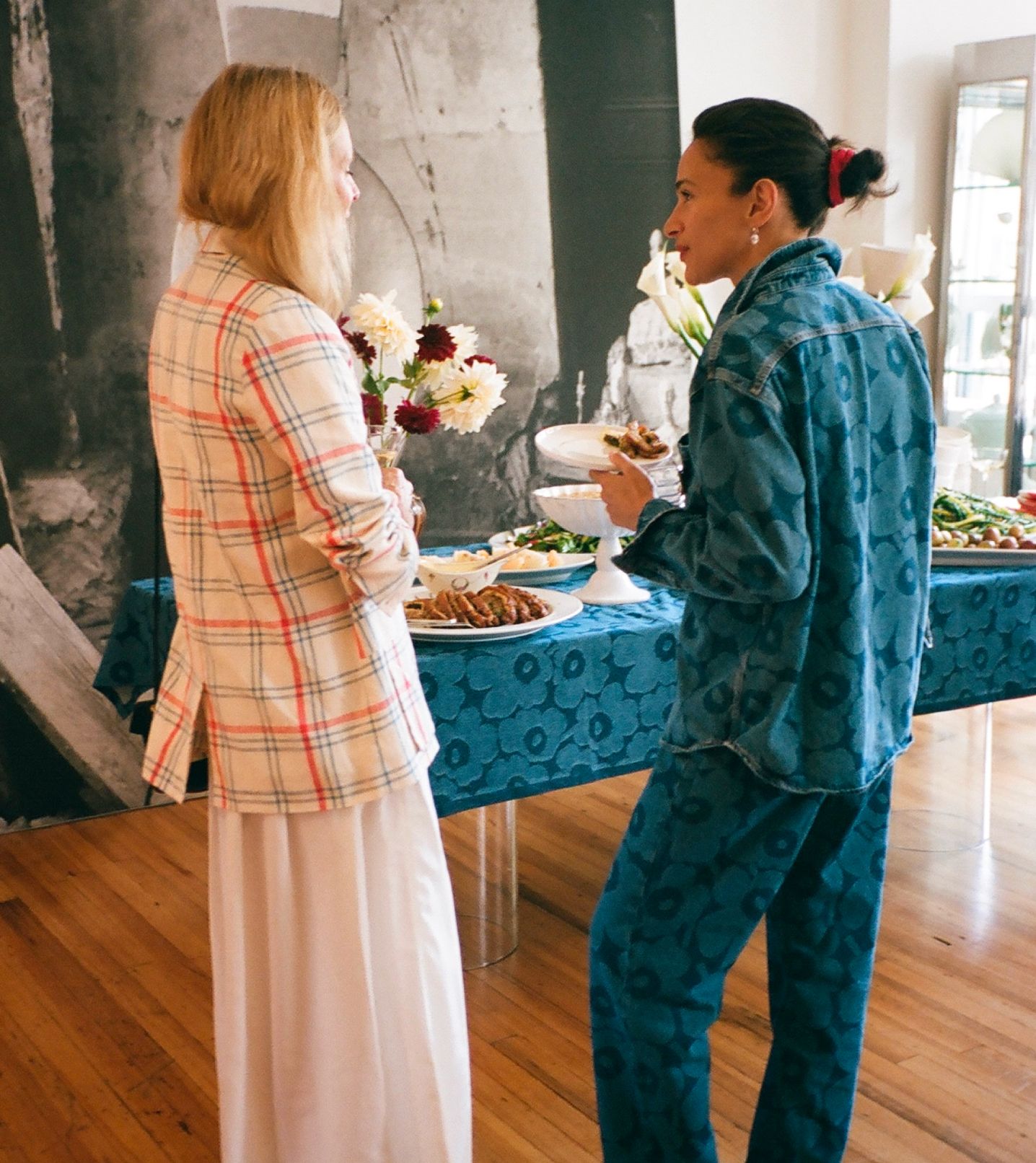 Laila Gohar chatting with a guest in front of the lunch table