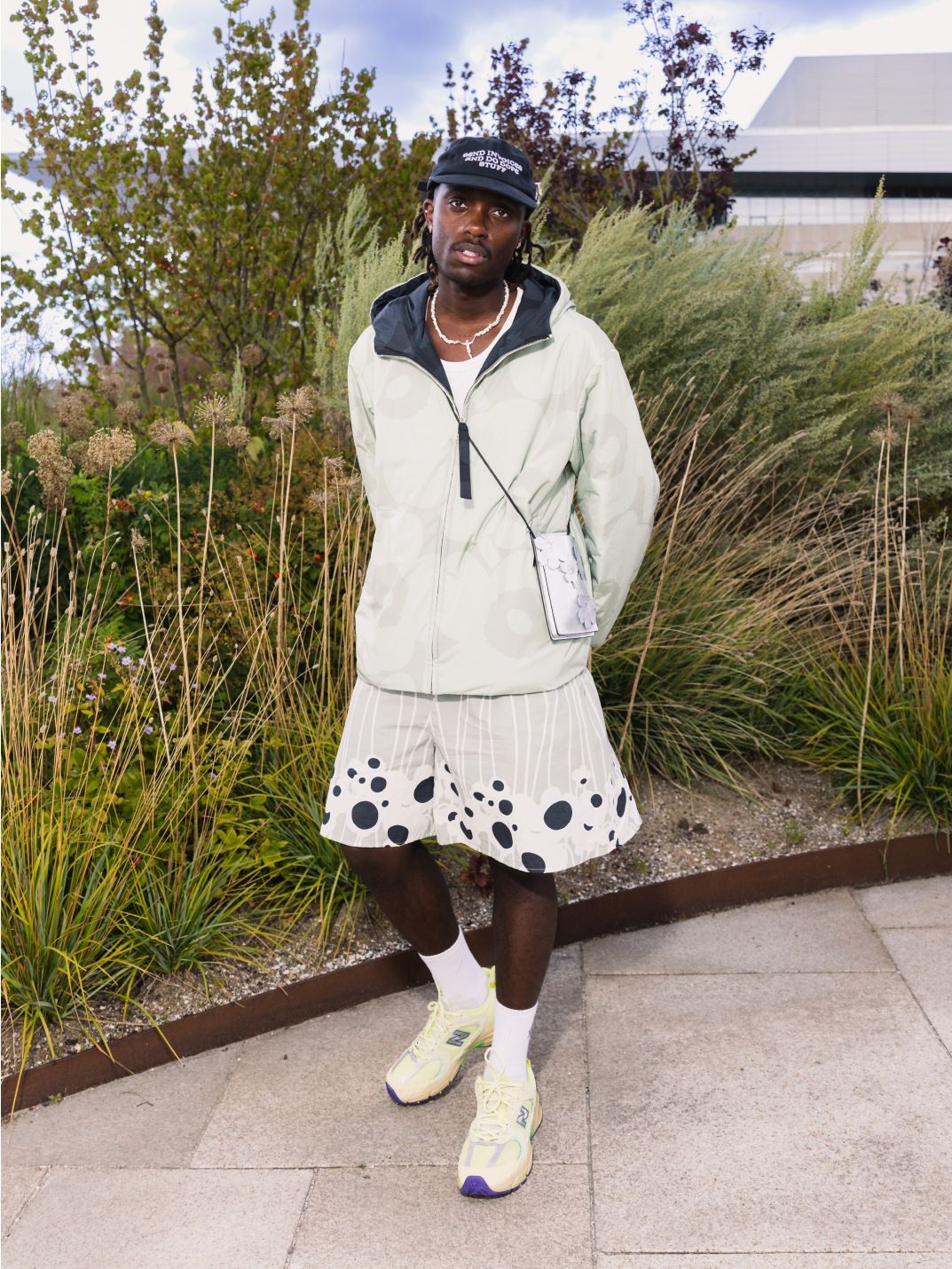 Richard Ntege in a light green Unikko patterned jacket and light green shorts.