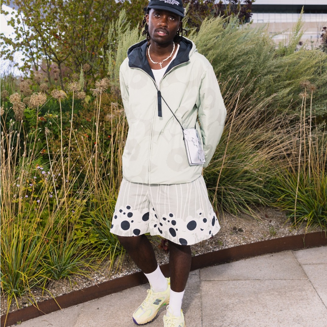 Richard Ntege in a light green Unikko patterned jacket and light green shorts.