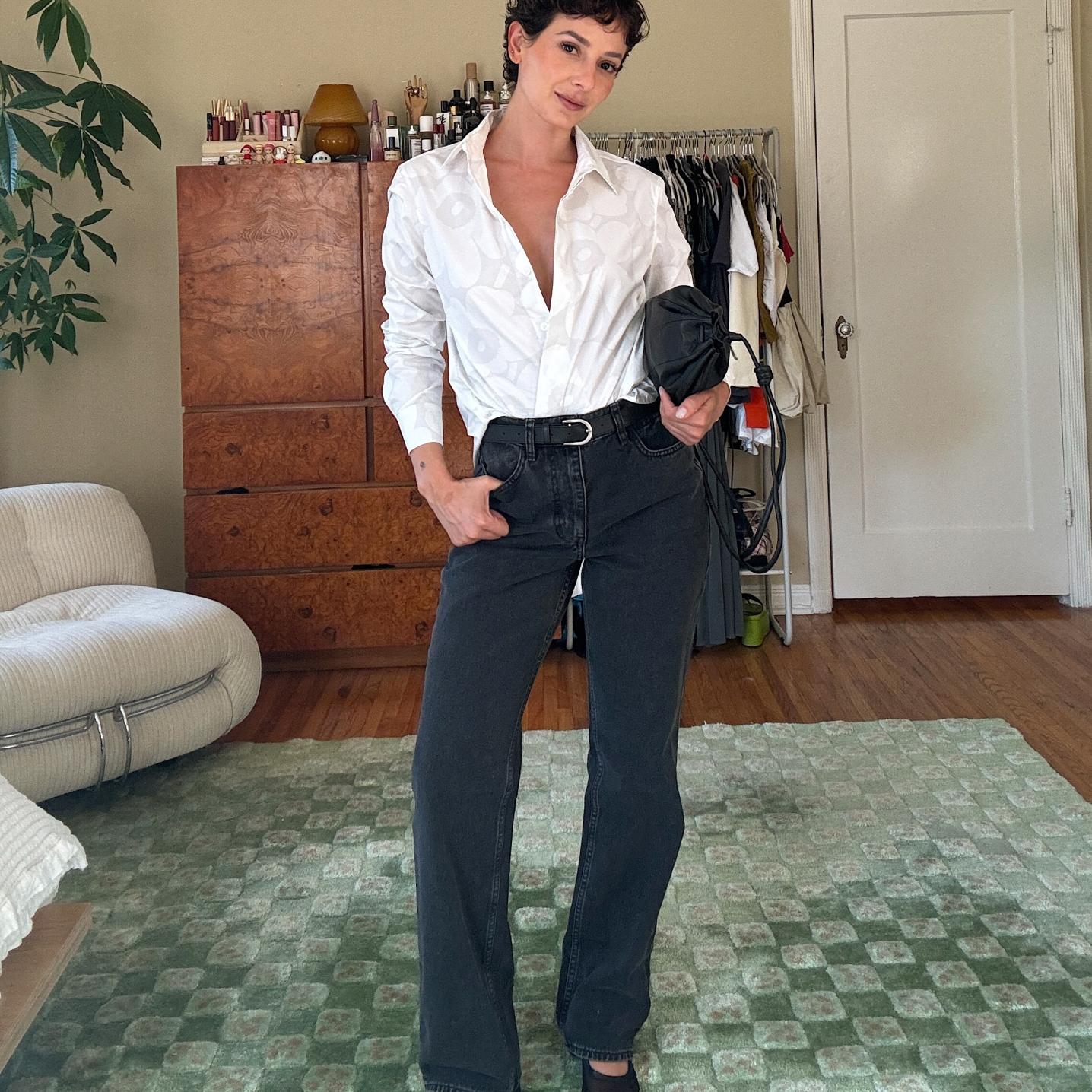 Alyssa Coscarelli dressed in black Maridenim jeans and a white Unikko collared shirt.