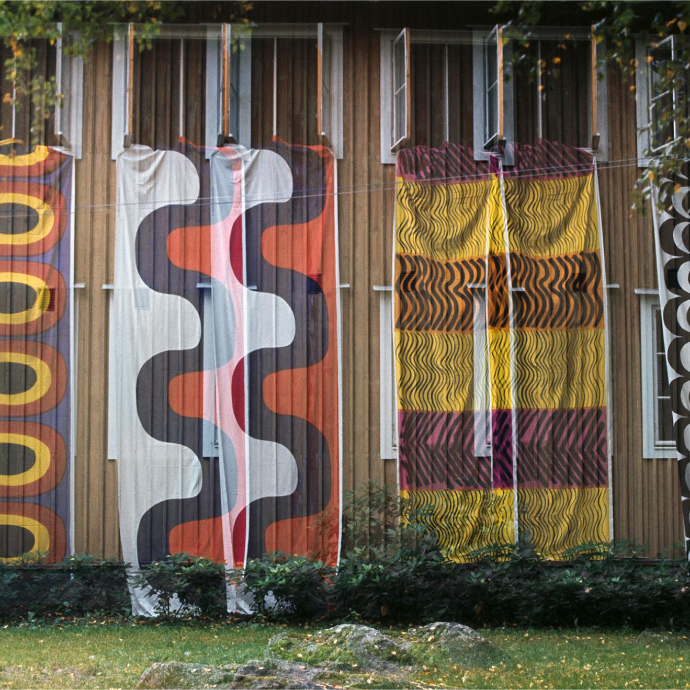 Achive picture where fabrics in Melooni and Seireeni patterns are hanging on the wall.