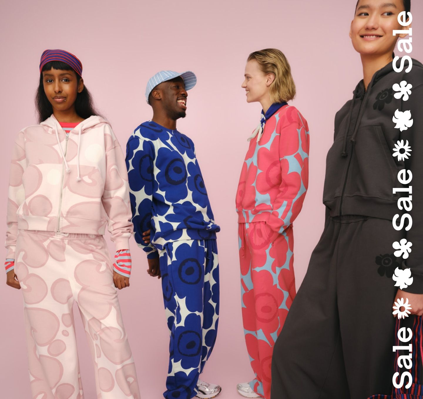 Models are wearing a Kioski sweatsuit set and sale text stripe vertically on the right.