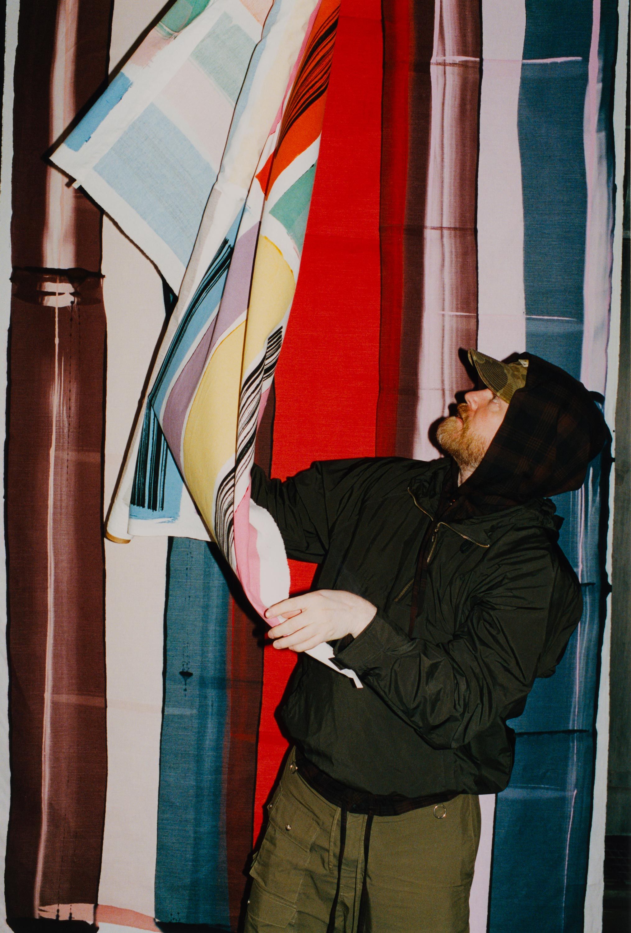 Designer Rolf Ekroth looking at Vibeke Rohland prints.