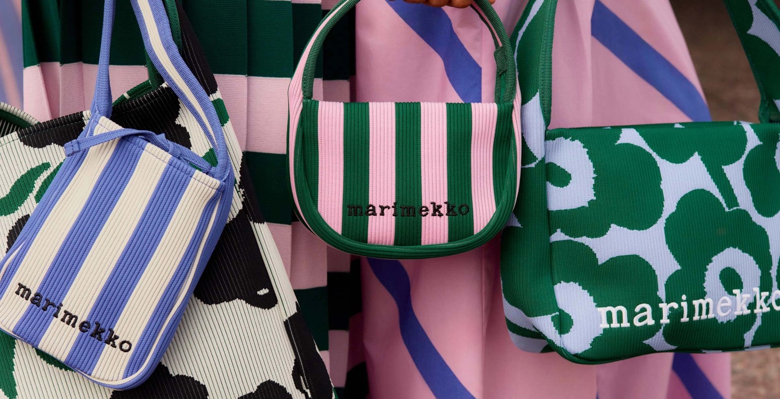 Models holding a selection of knitted bags in various color combinations.