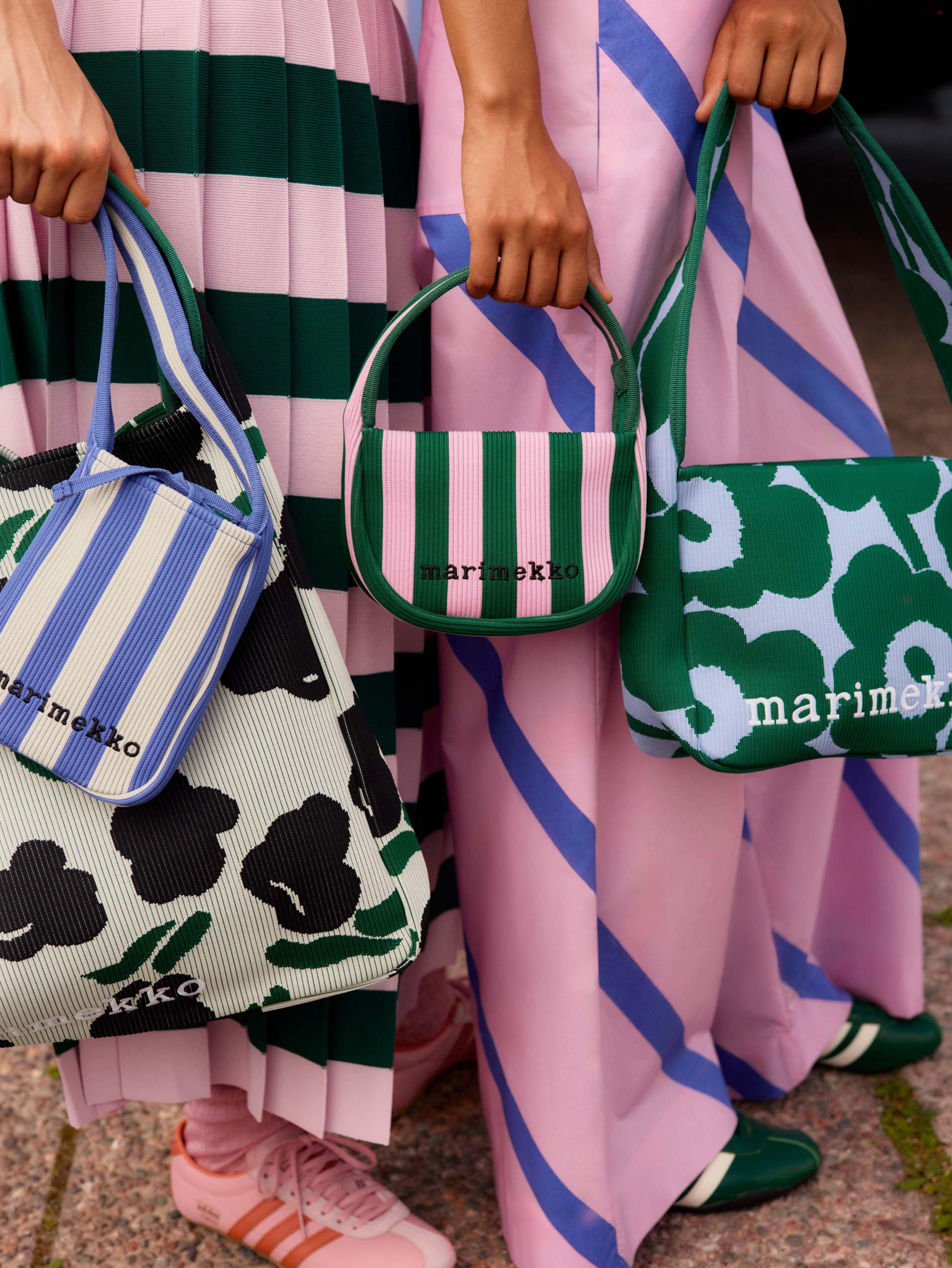 Models holding a selection of knitted bags in various color combinations.