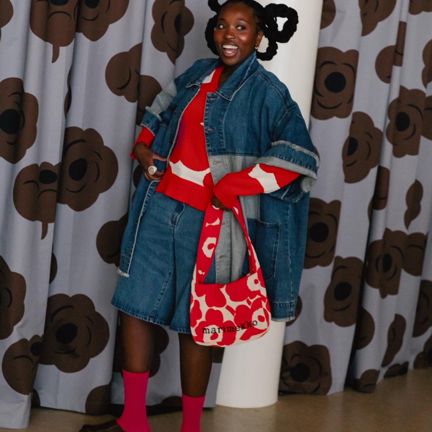 Happy Raquel Costa Gomes dressed in a red and white Marimekko knit and a matching Marimekko bag