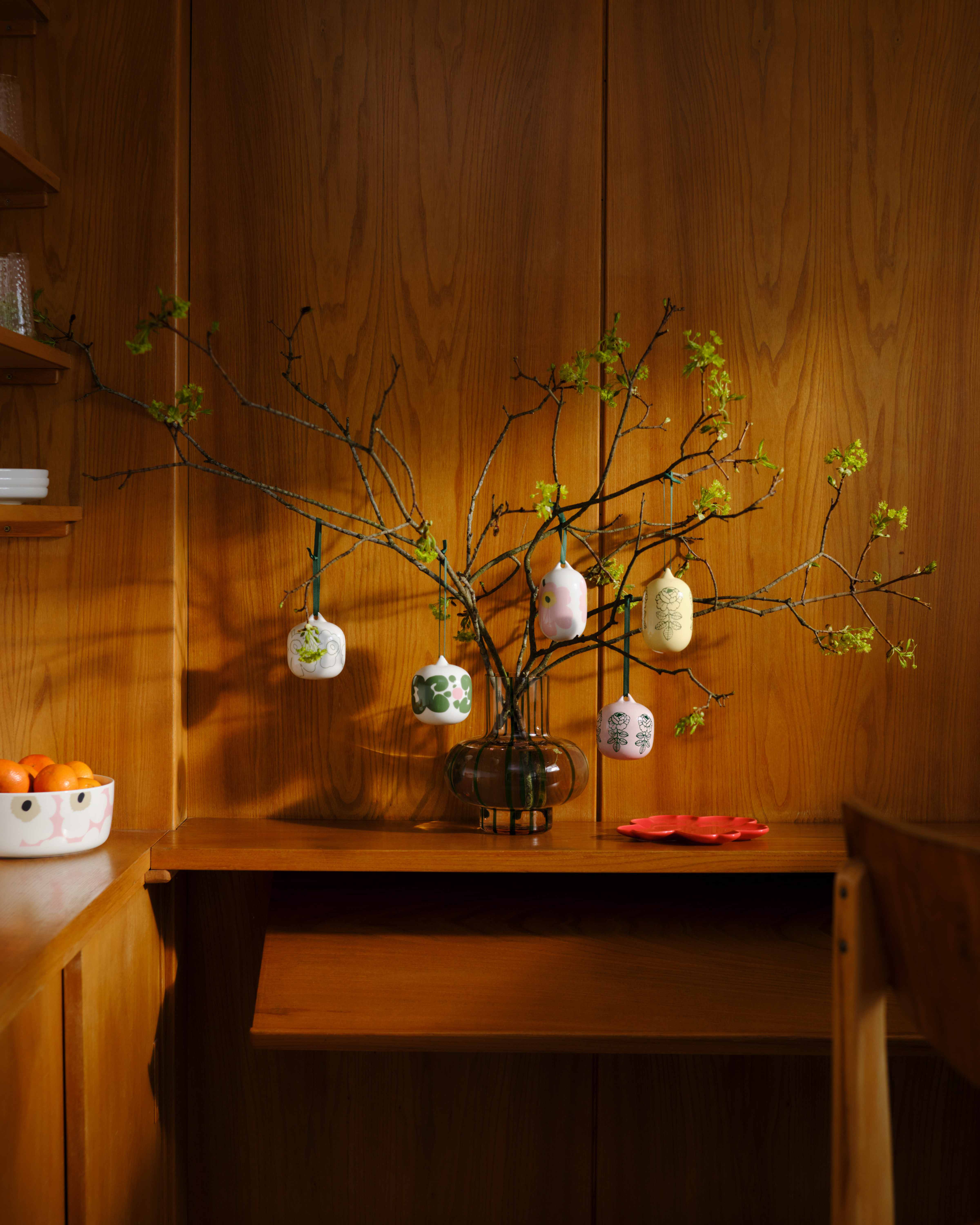Vase with branches decorated with various ornaments in Marimekko's Unikko, Vihkiruusu, and Keidas prints