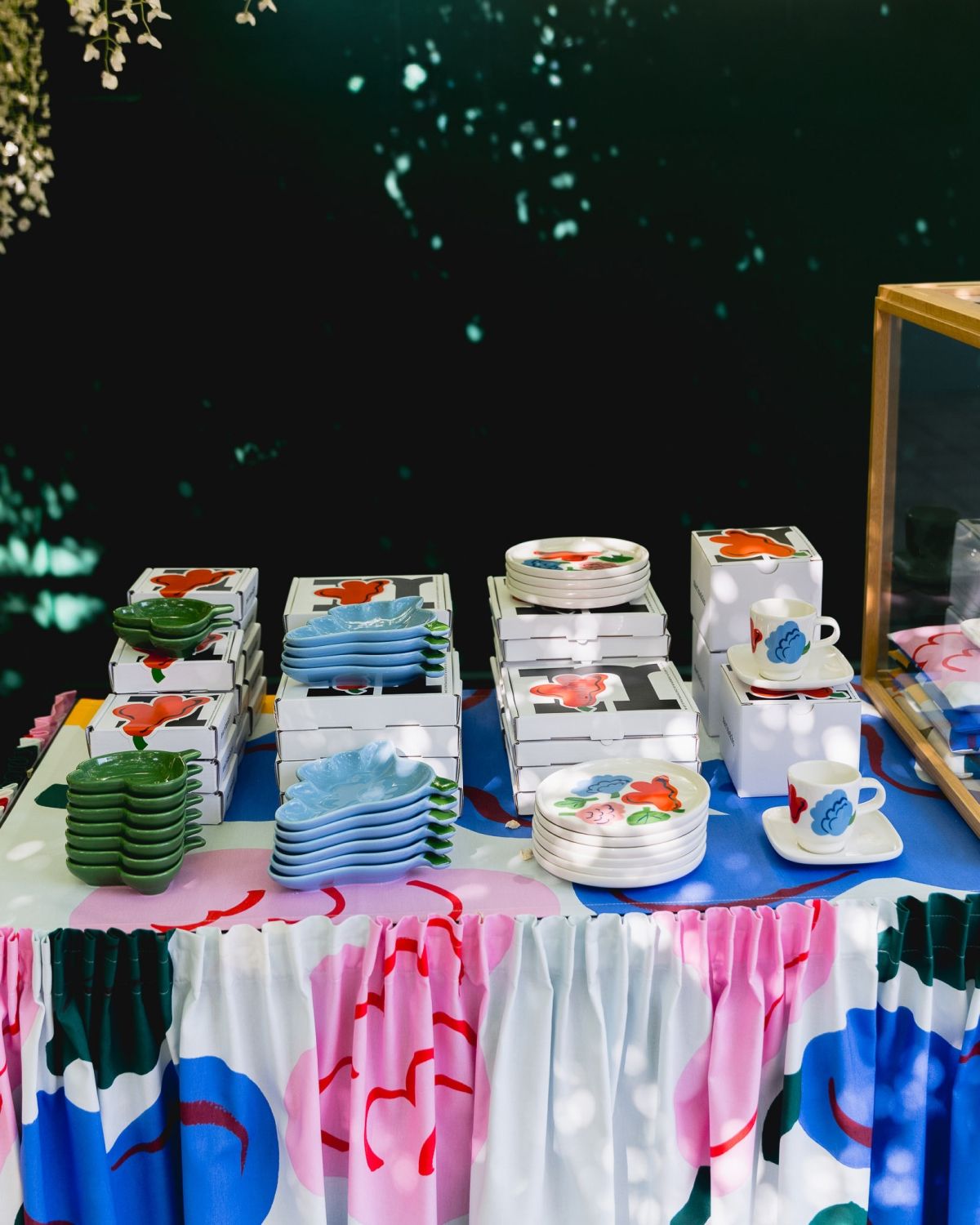 Tableware with Kukasta kukkaan print stacked on a table.