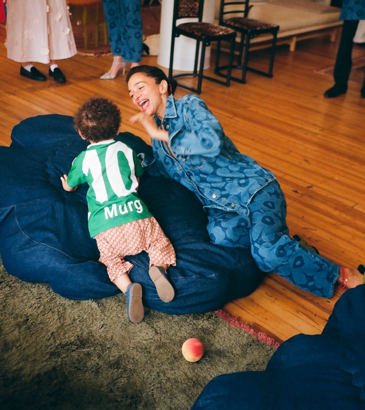 Laila Gohar and the child on a huge denim Unikko seat cushion